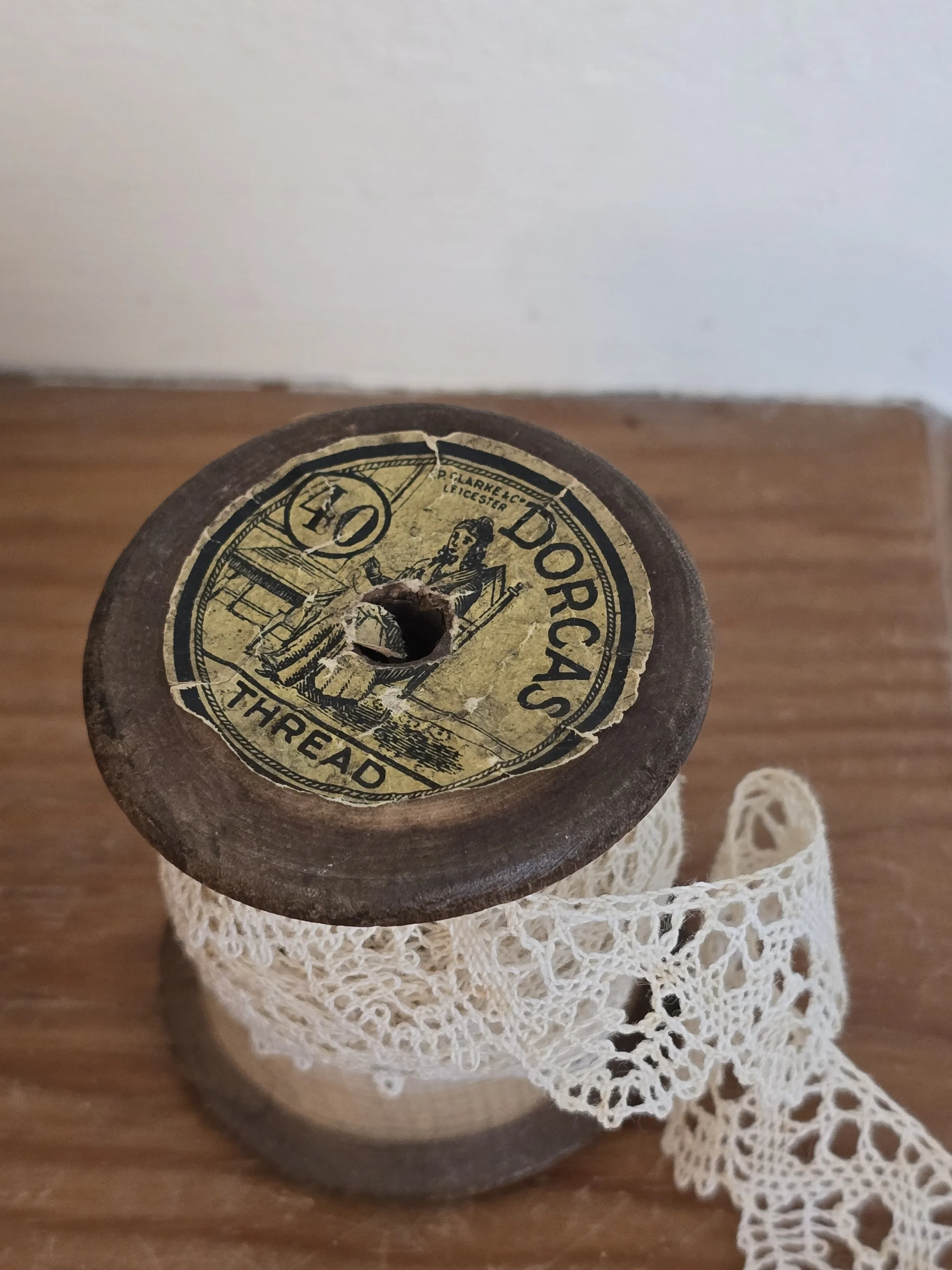 timeworn lace on antique thread spool