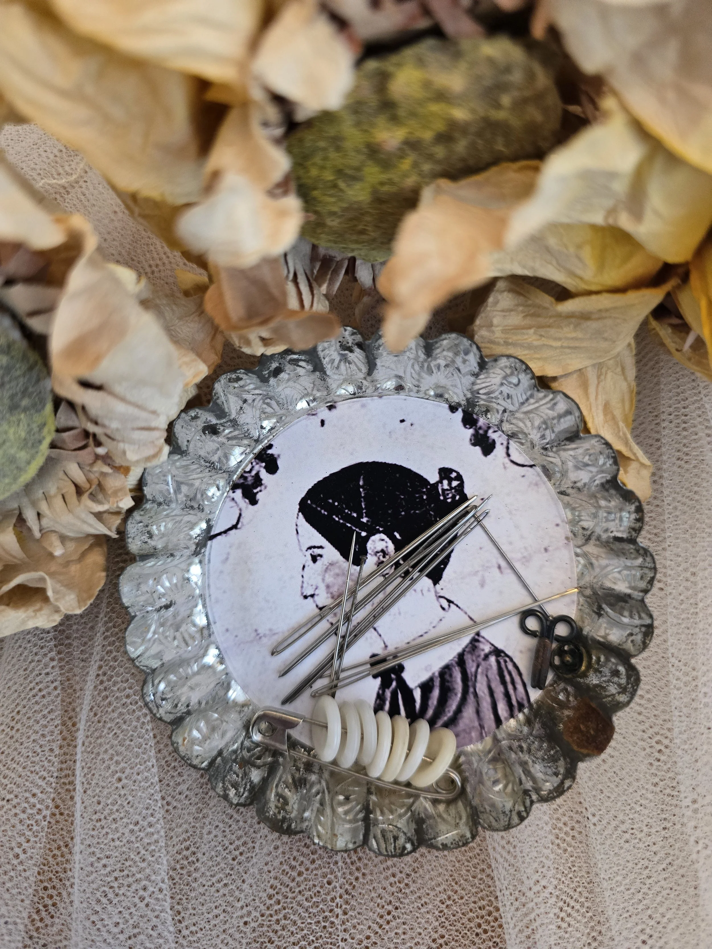 Primitive folk art needle keep made from a vintage French pastry mould.