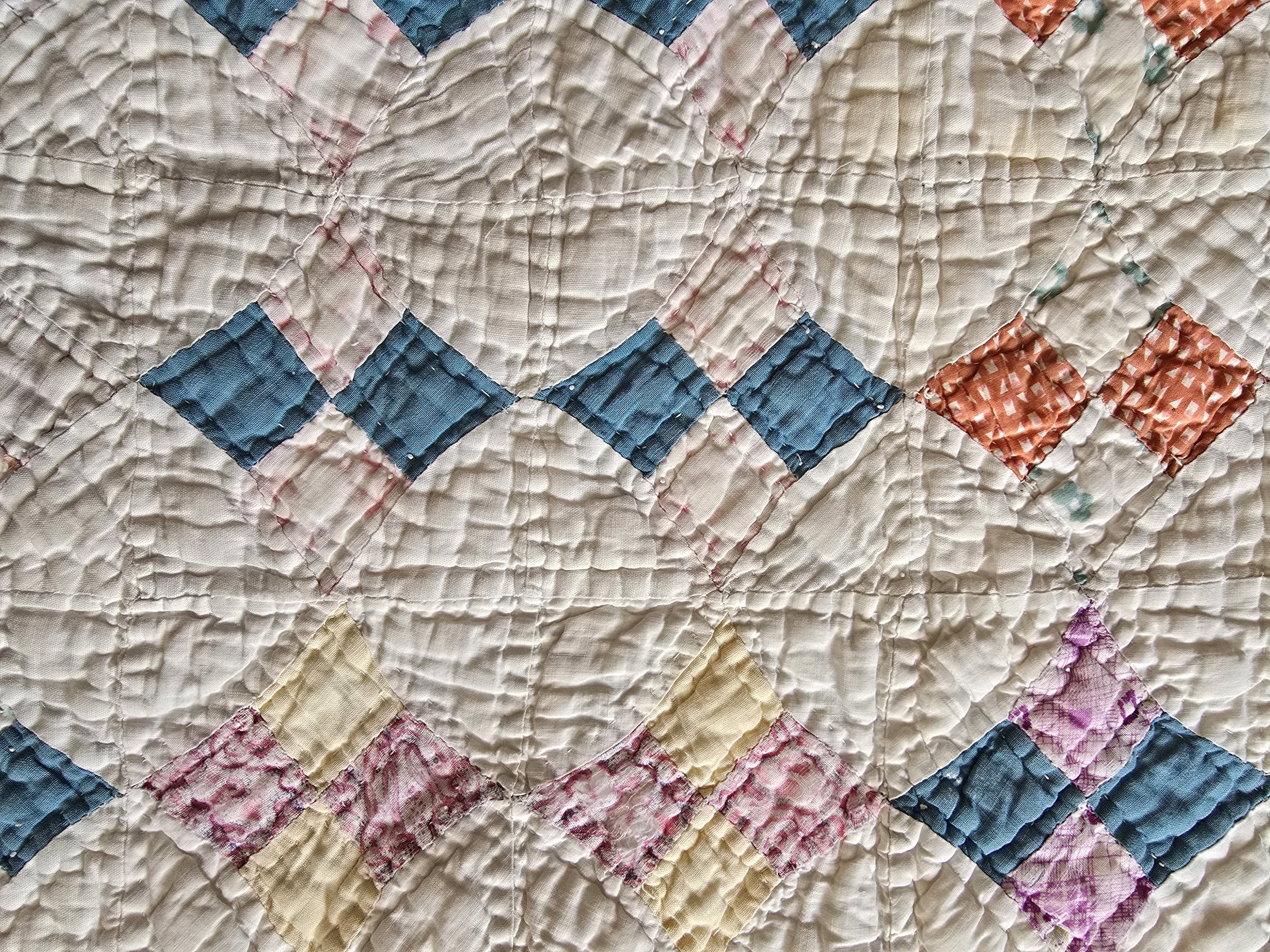 Antique quilt remnant with multicolour patchwork
