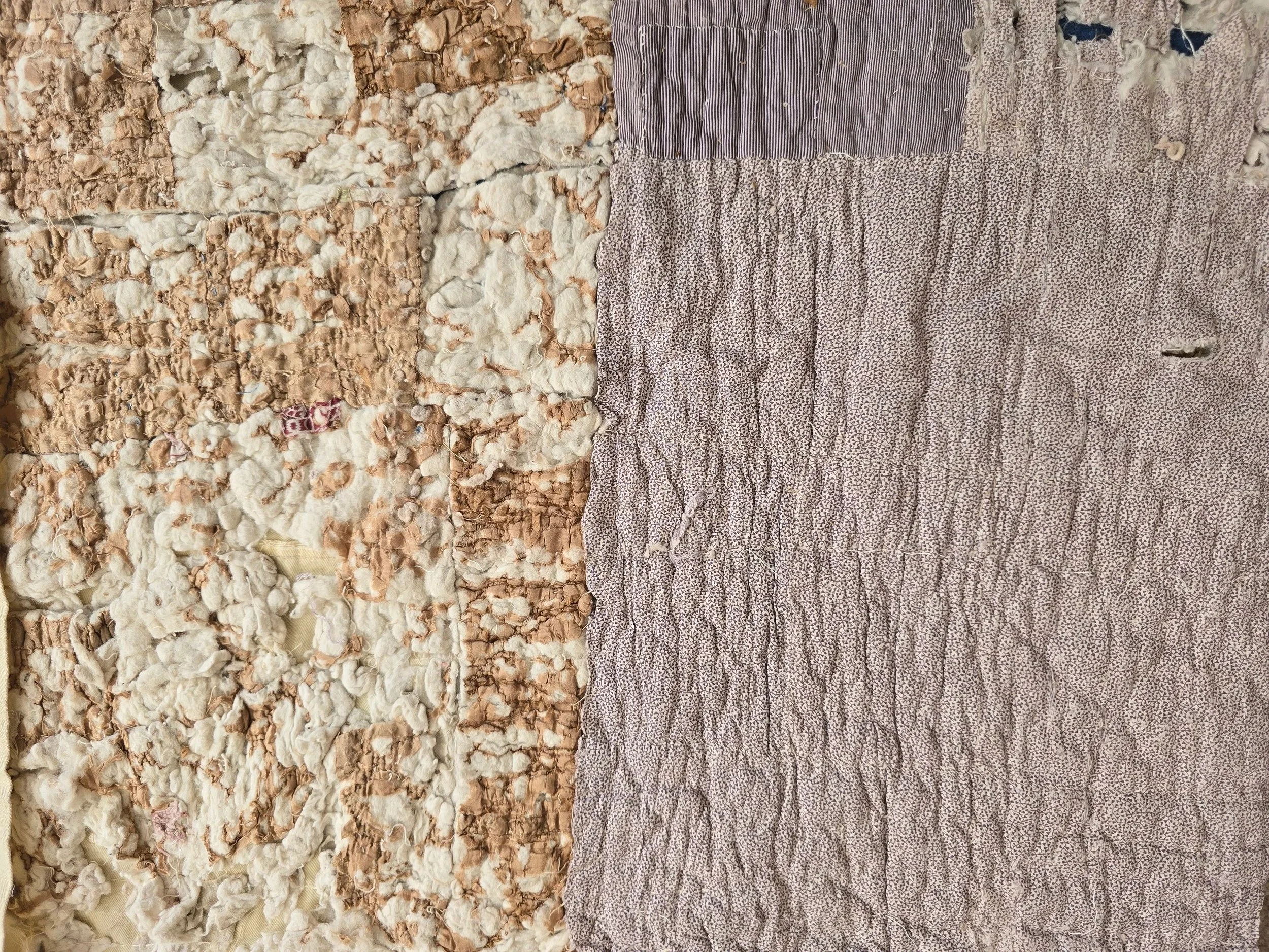 Antique French quilt fragment measuring 47 x 42 cm with faded purple printed cotton and exposed layers.