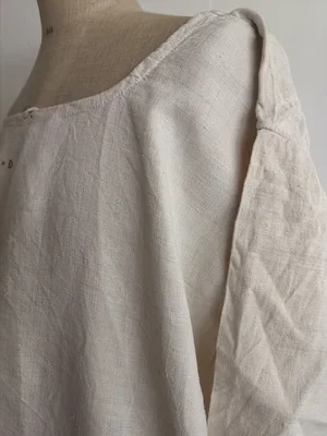 Sleeve detail of antique French linen chemise with hand stitching