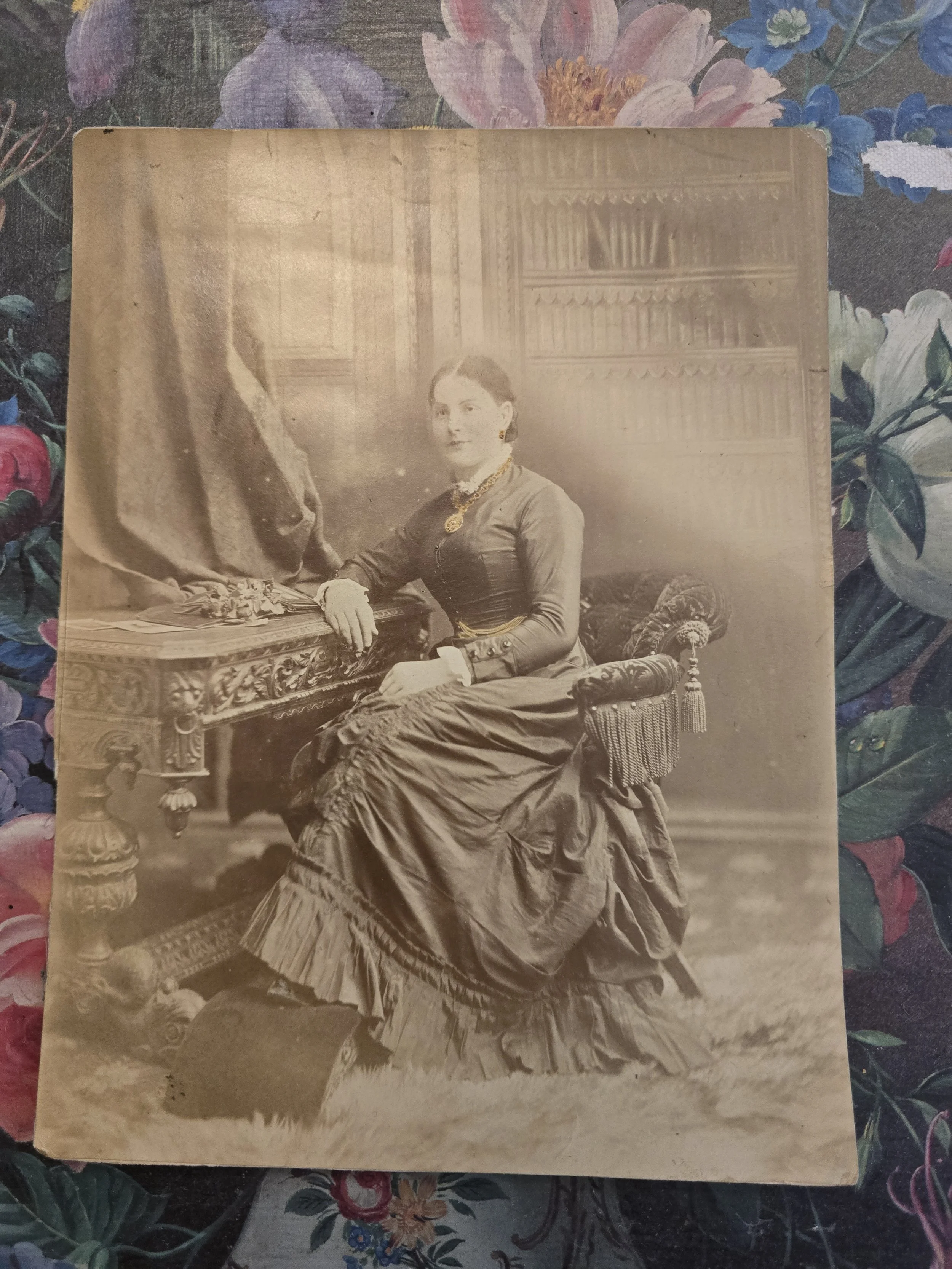 Original Victorian sepia portrait of a seated woman beside an ornate carved table