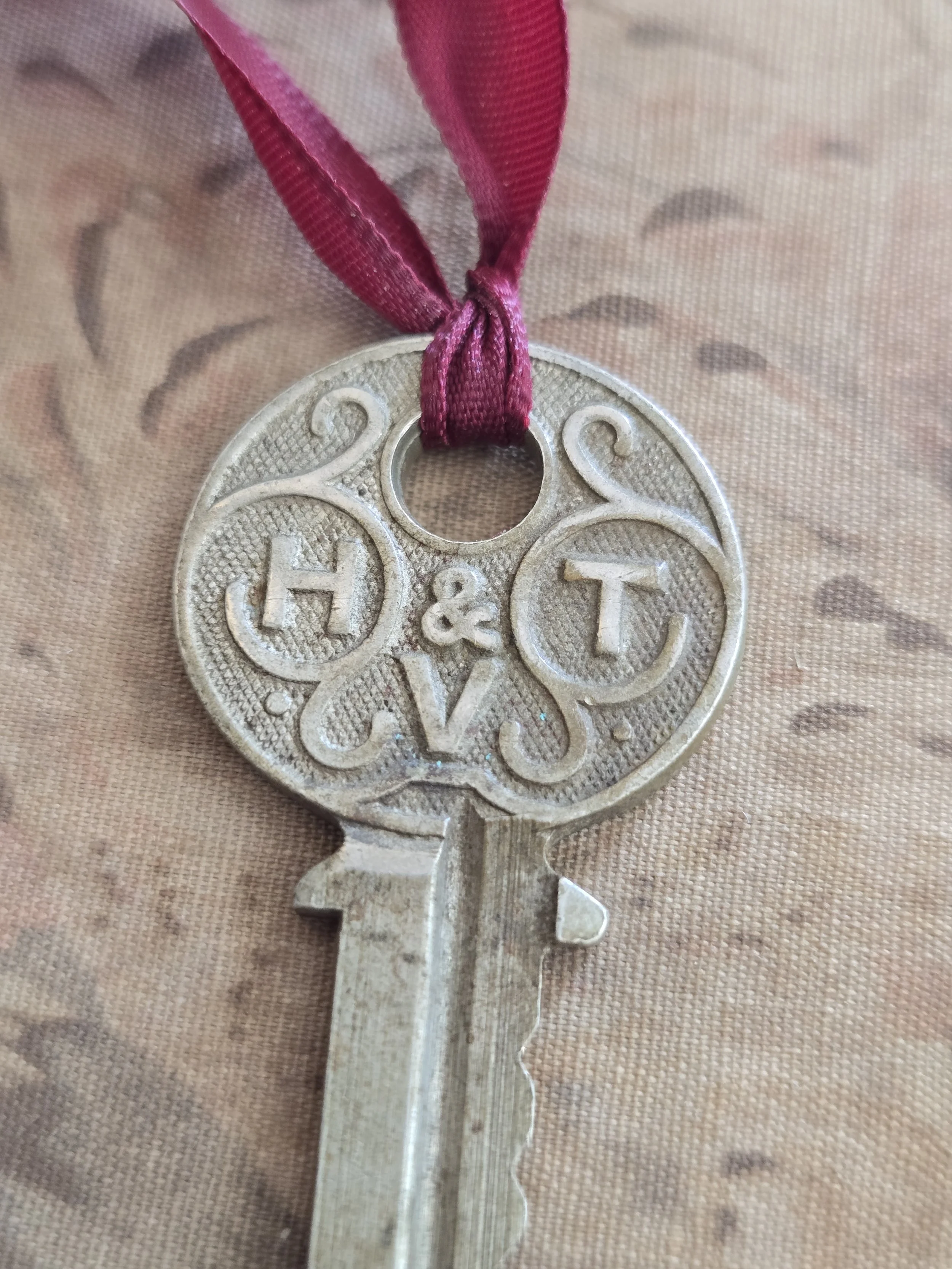 Timeworn iron keys with decorative ribbon detail.