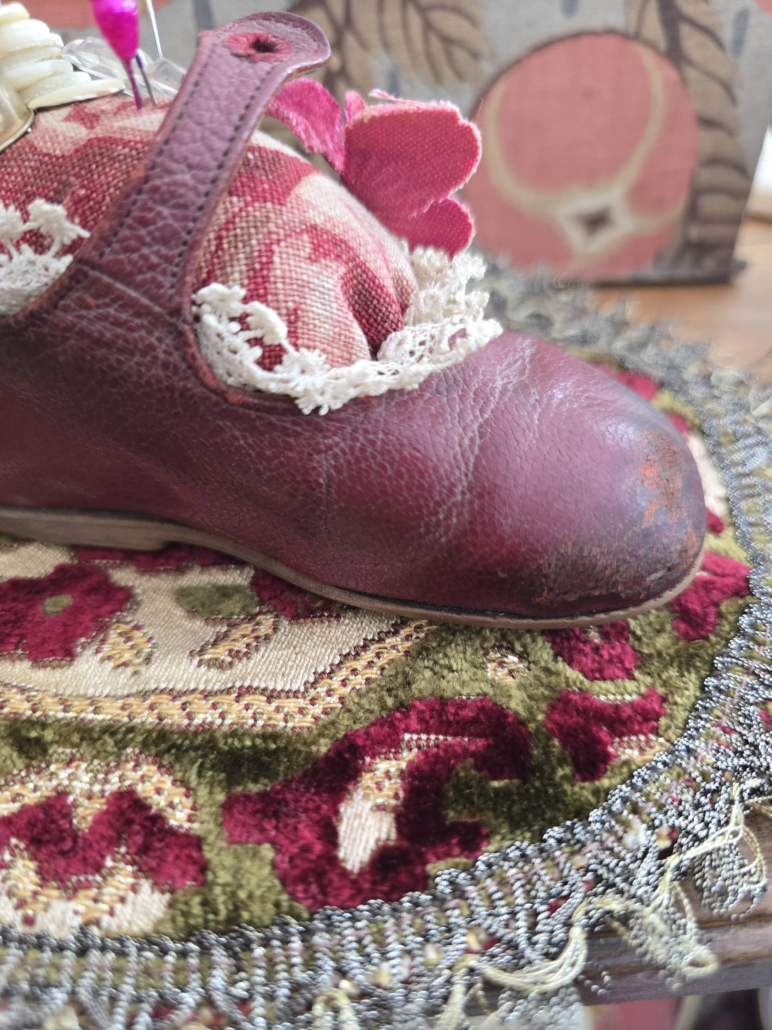 Rear view showing the original leather strap and antique lace edging.
