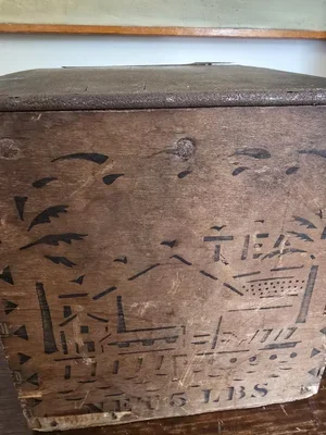 Textured corner of crate showing rusted lid edge and timeworn wood