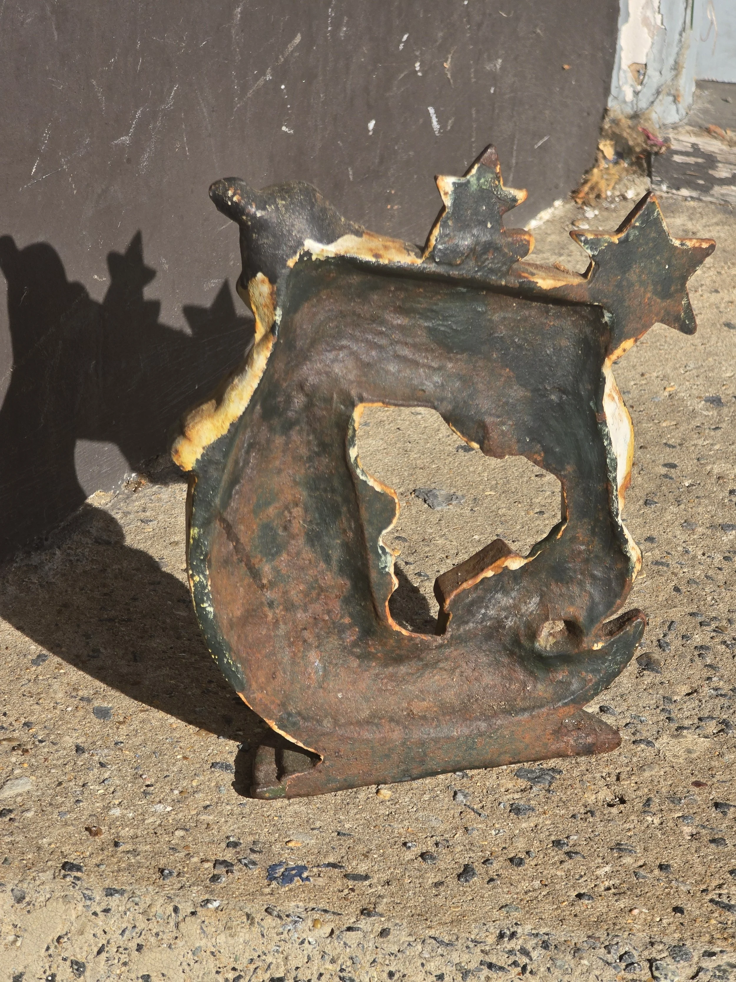 Reverse of the vintage metal cow jumping over the moon ornament showing extensive original rust and oxidation.