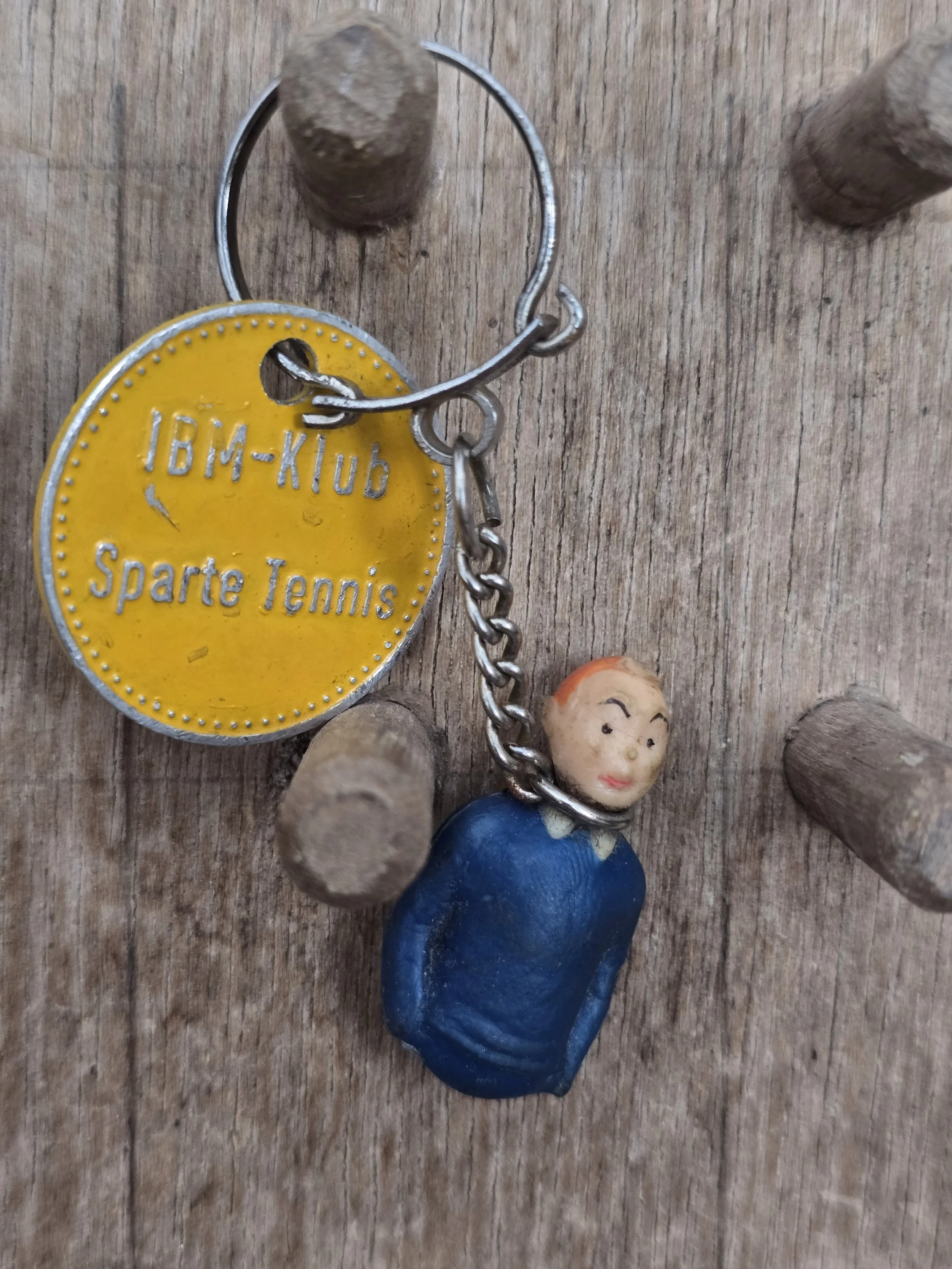 Collectible Tintin bust keychain with vintage IBM club membership fob.
