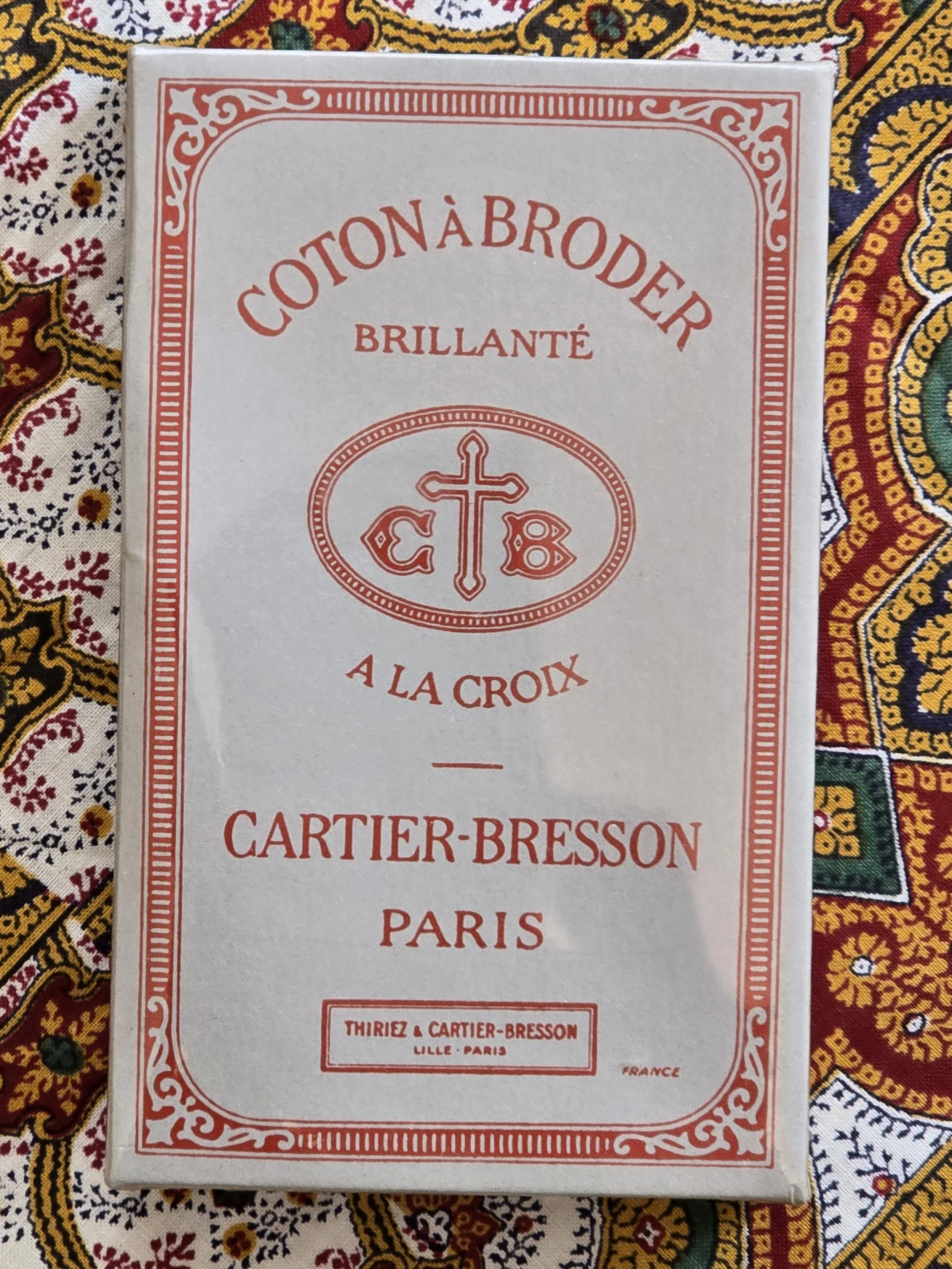 Eight white embroidery thread skeins in original presentation box.
