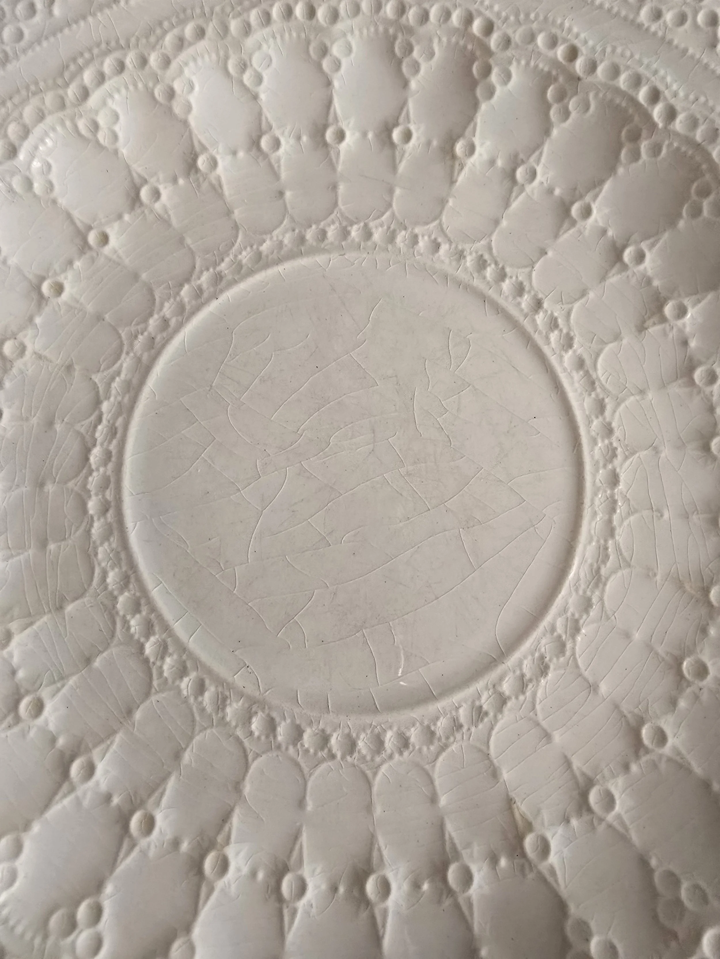vintage white plate with doily inspired embossed design and textured surface