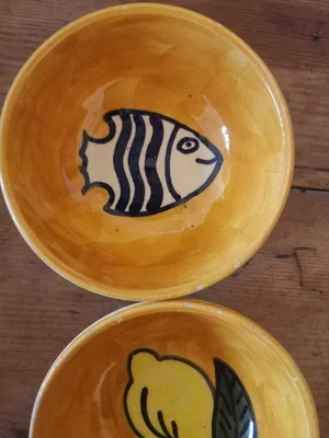 1970s Tunisian Nabeul pottery bowl with bold black striped fish on yellow glaze