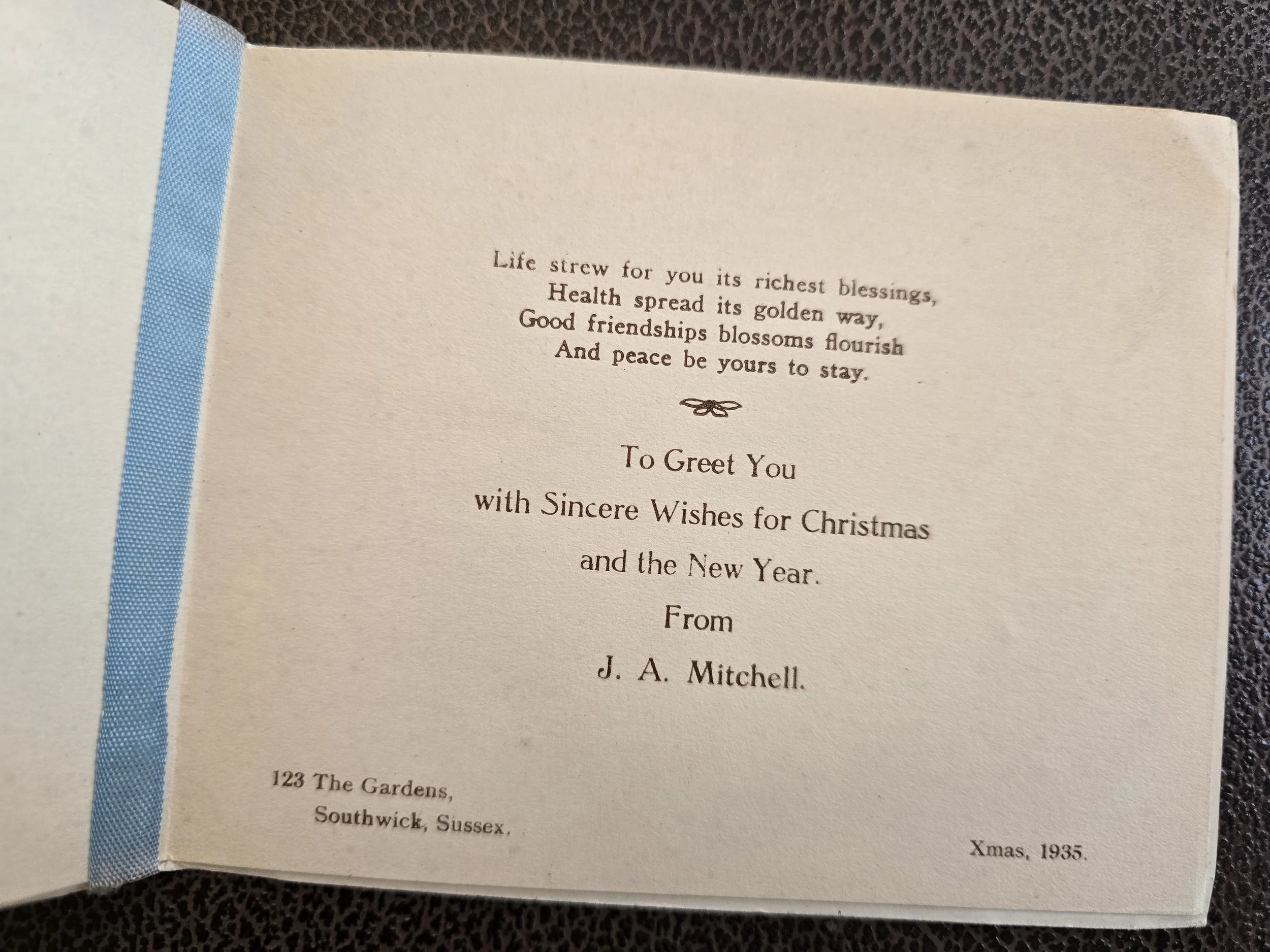 Inside of a vintage Christmas card dated 1935, with printed festive greetings and the original sender's name and Southwick, Sussex address.