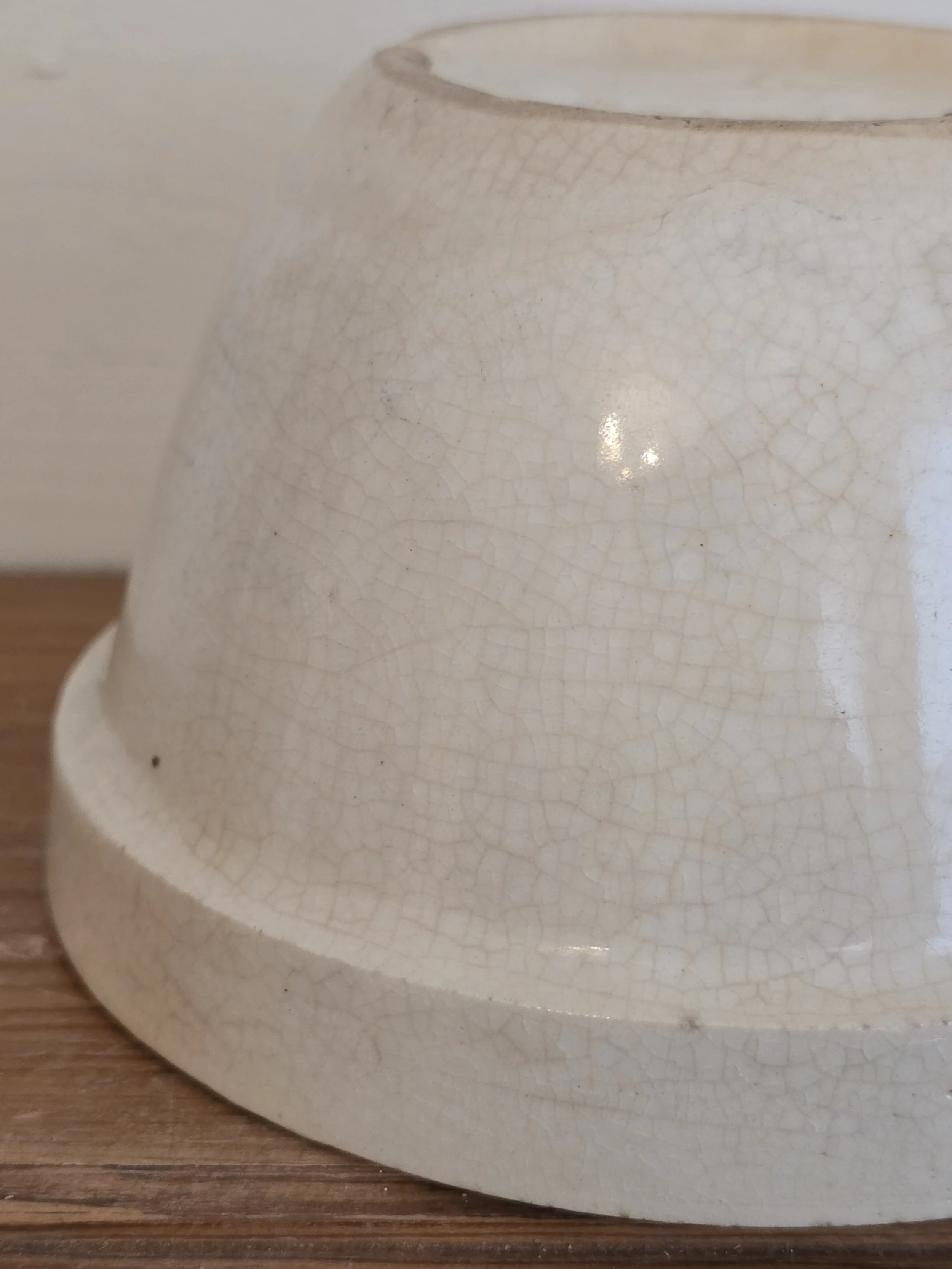 Base of small vintage British pudding bowl with crazed ivory glaze