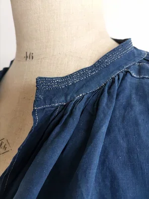 Hand-stitched collar detail with pleating on antique biaude smock.