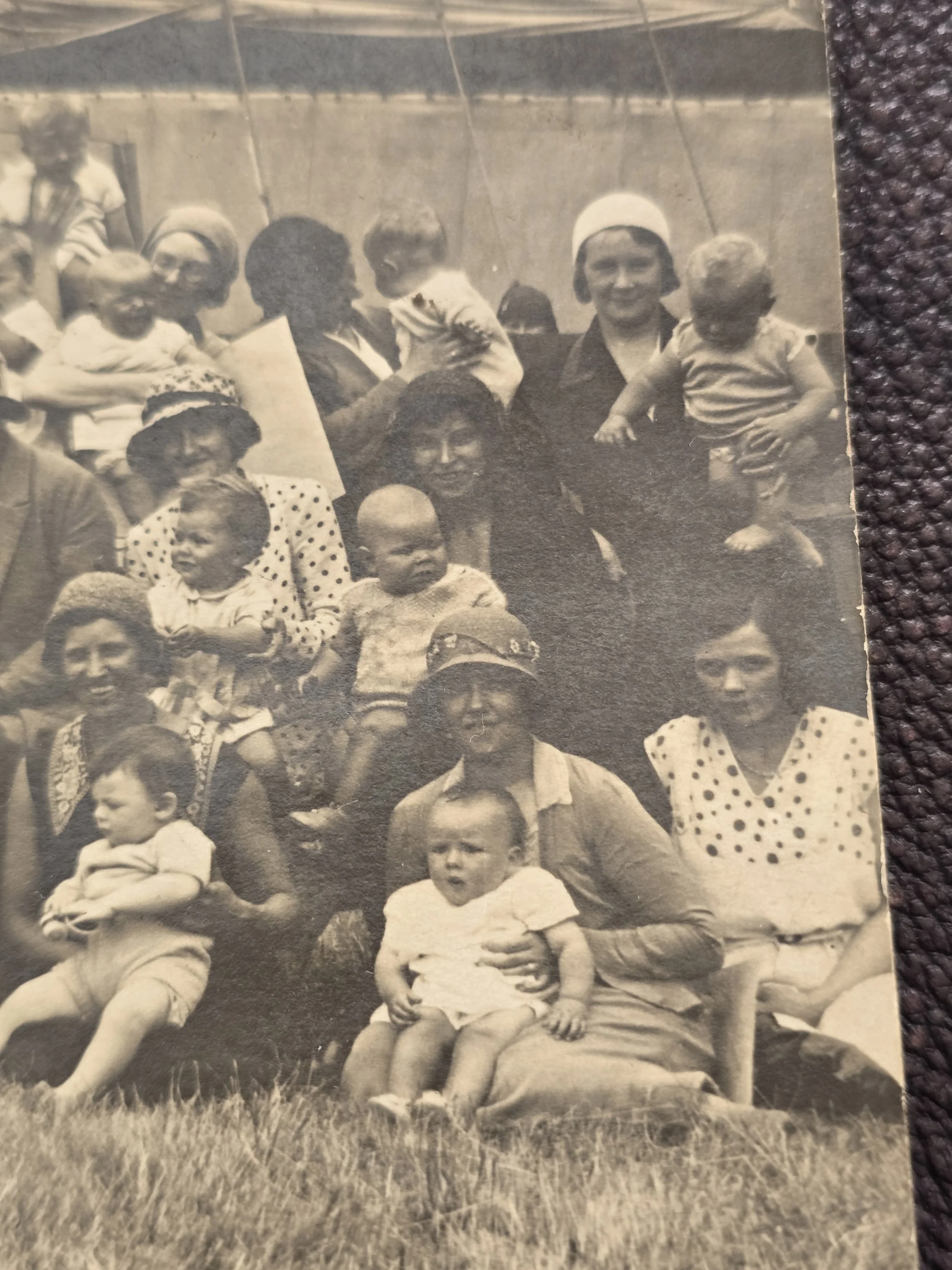 Detail of vintage 1930s photograph showing women in cloche hats with babies and toddlers.