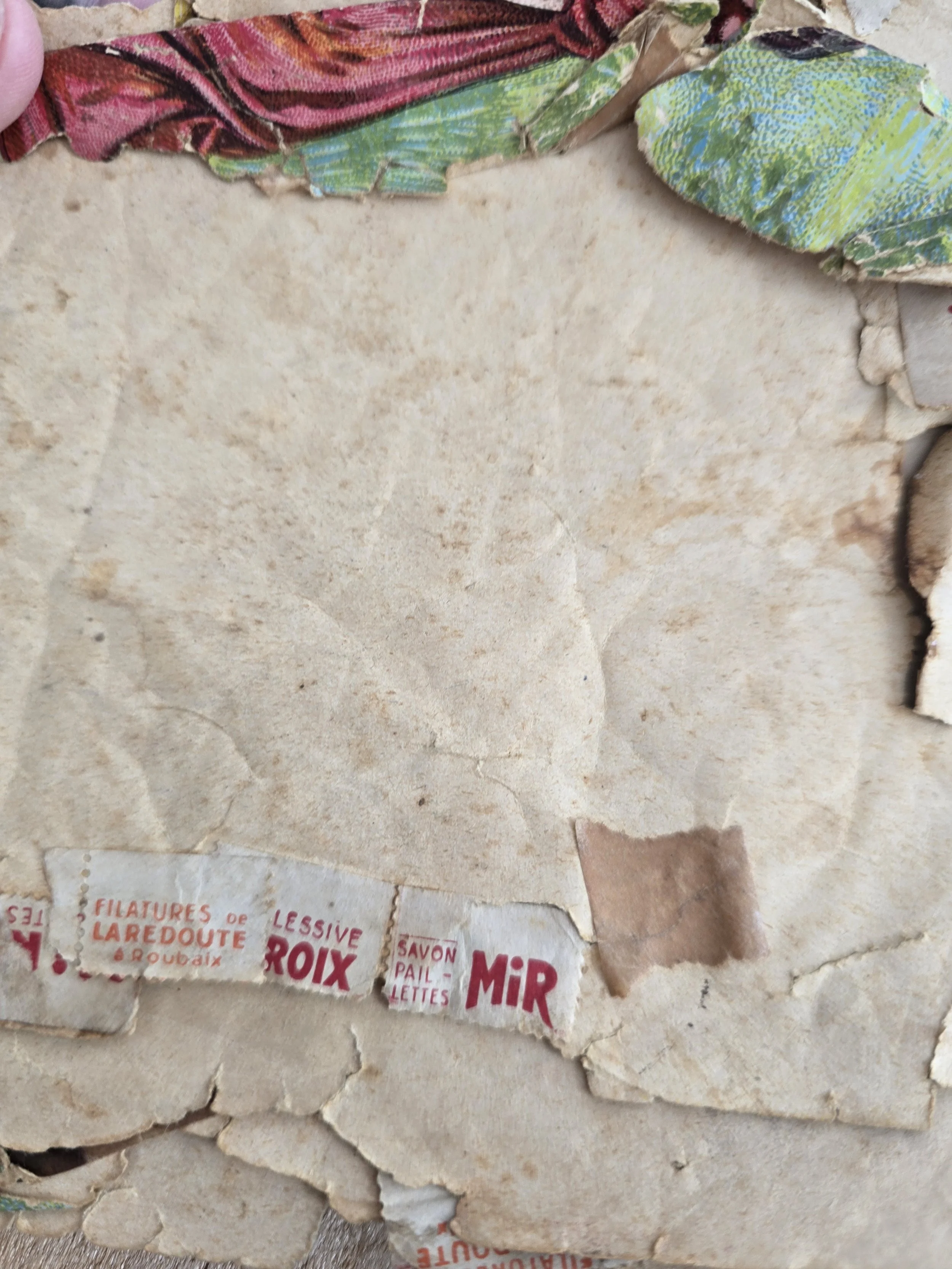 interior of box with layered old paper and french text fragments