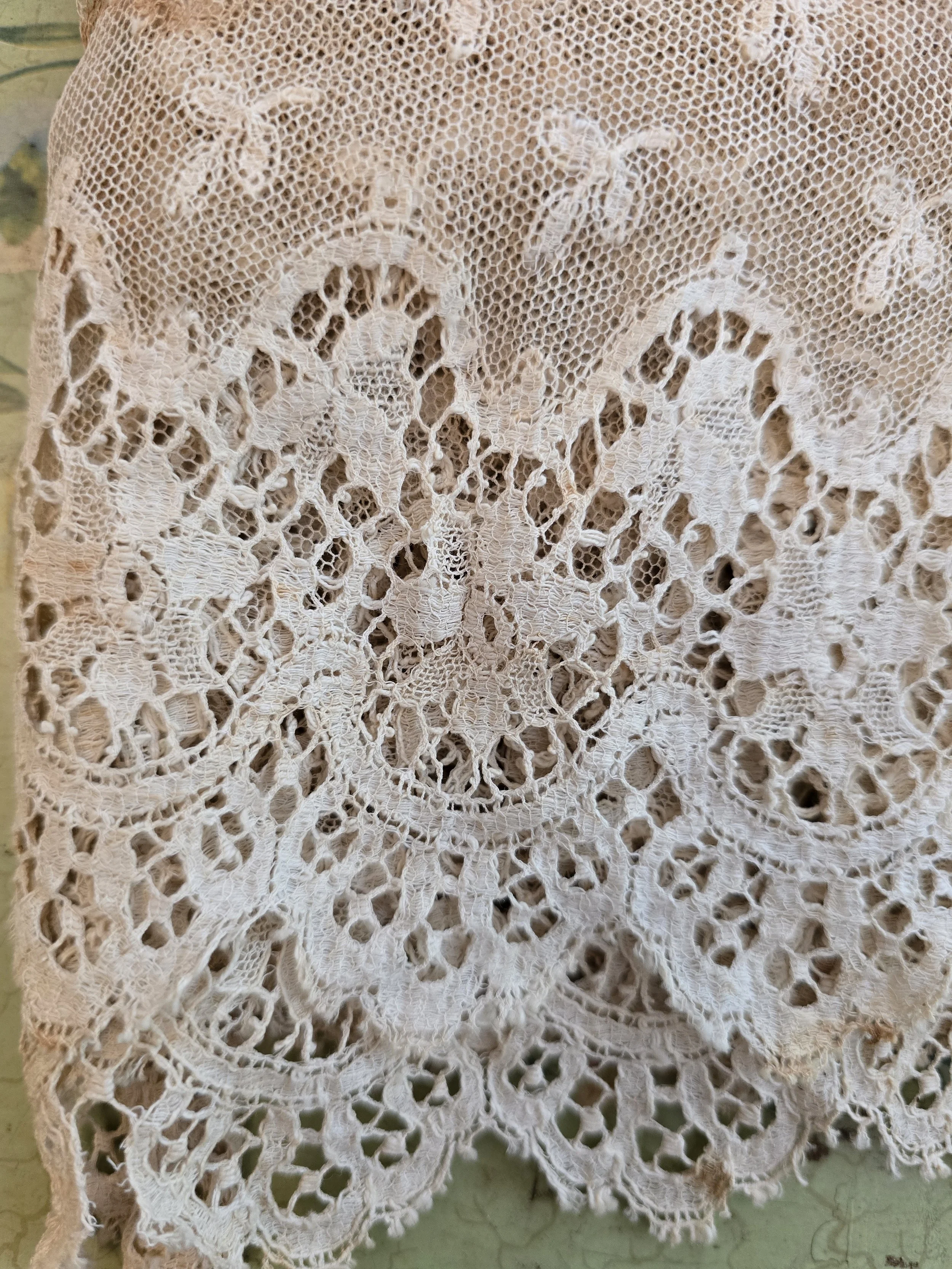 Timeworn cream antique lace fragment with romantic detailing