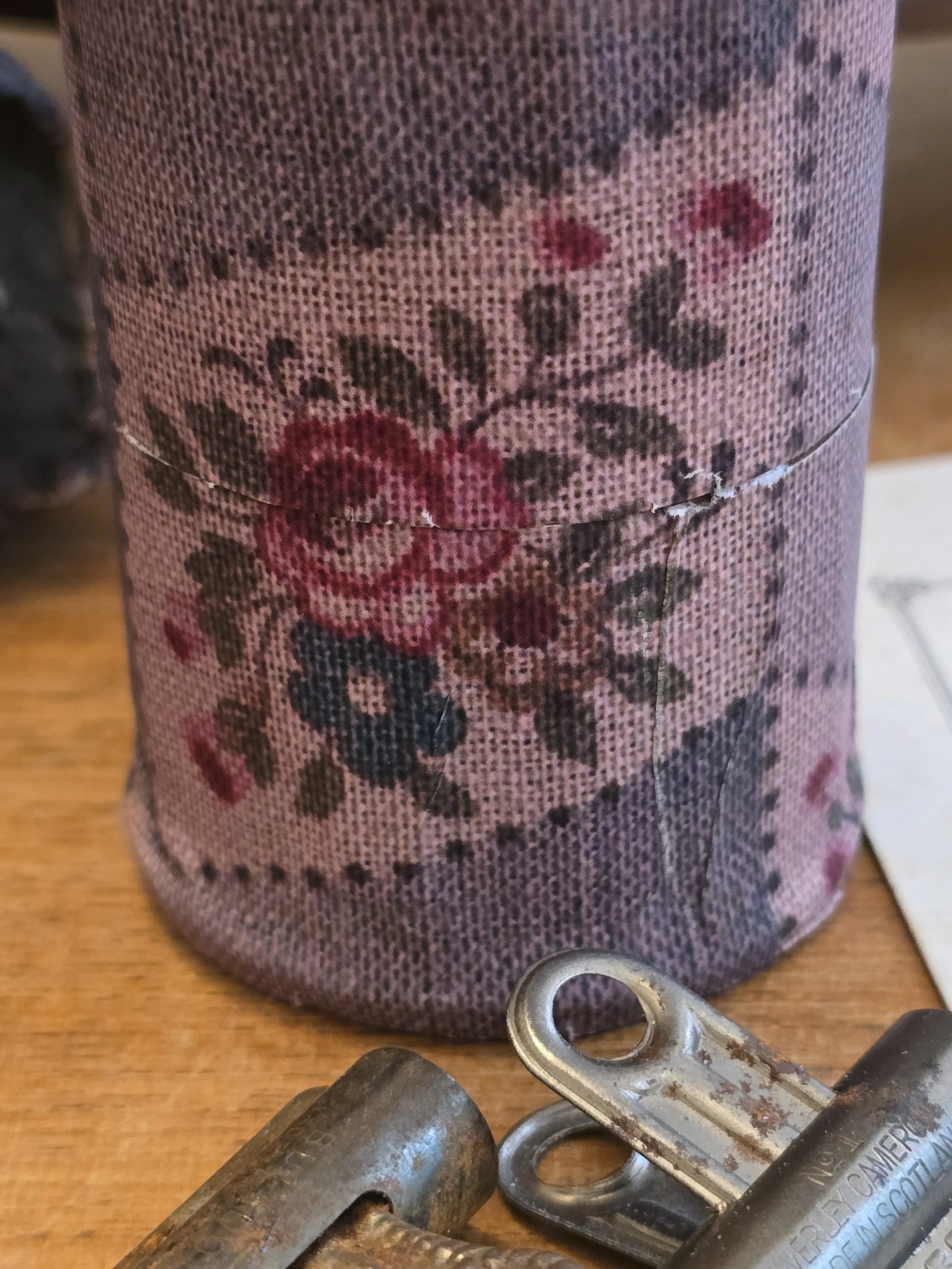 small handmade decorative box with pink roses, blue flowers and faded geometric pattern