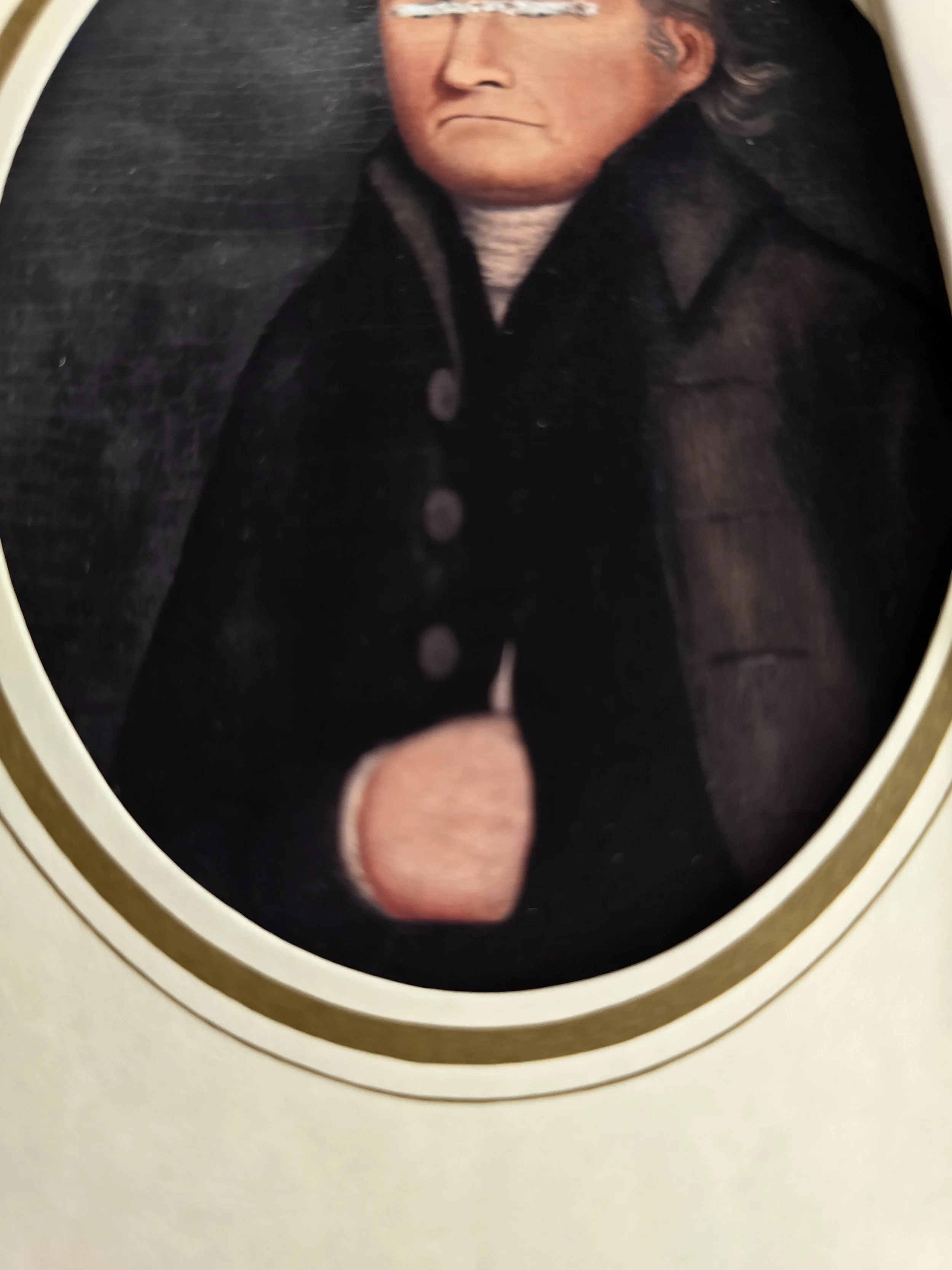 Close-up of altered vintage gentleman portrait with scratched-out eyes on unusual Halloween card.