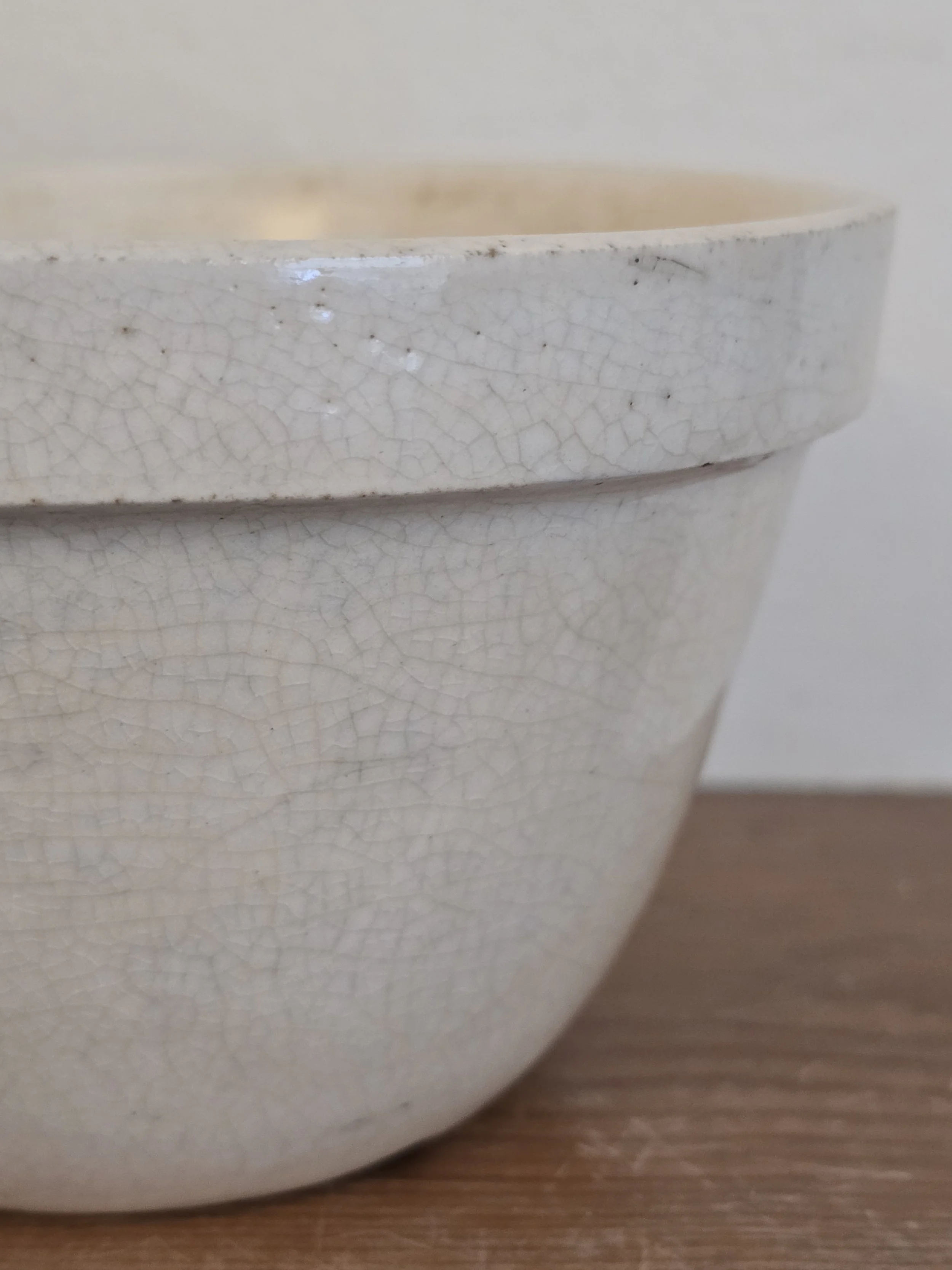 Side view of antique British stoneware pudding bowl with crackled surface