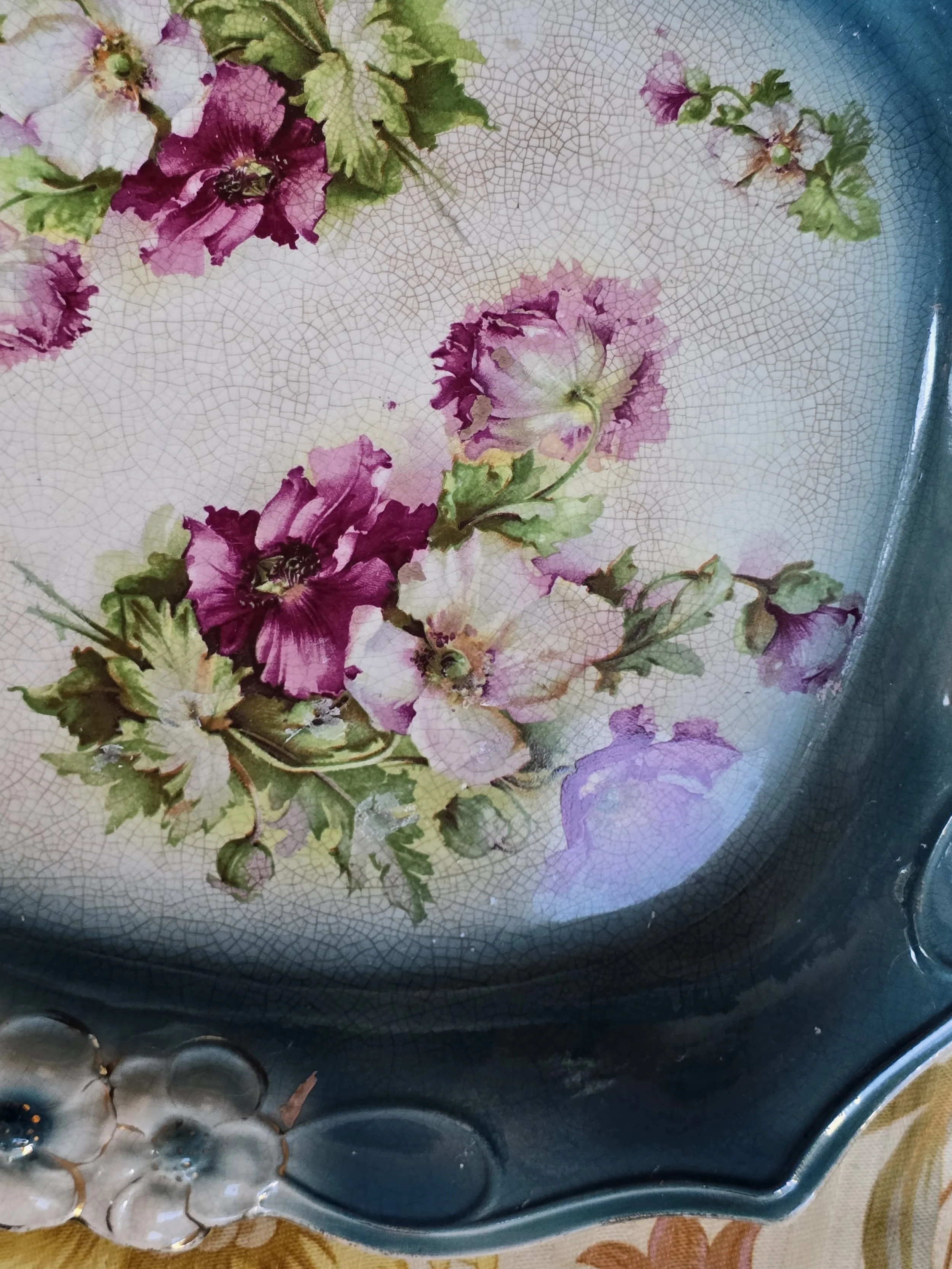 Underside of vintage ceramic tray showing extensive age-related crazing and small surface marks.