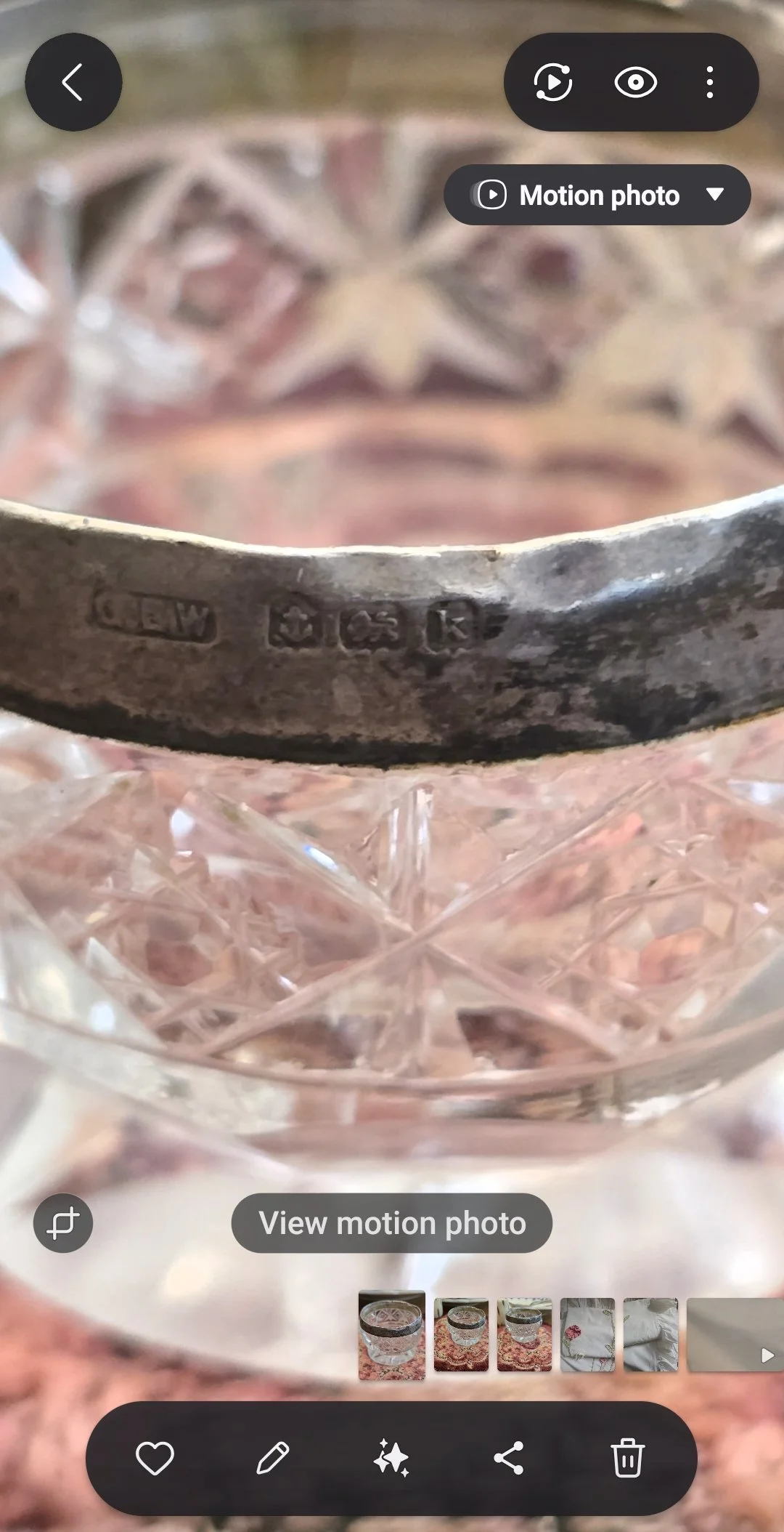 Close-up of hallmarks stamped into the silver rim of an antique cut glass salt cellar.