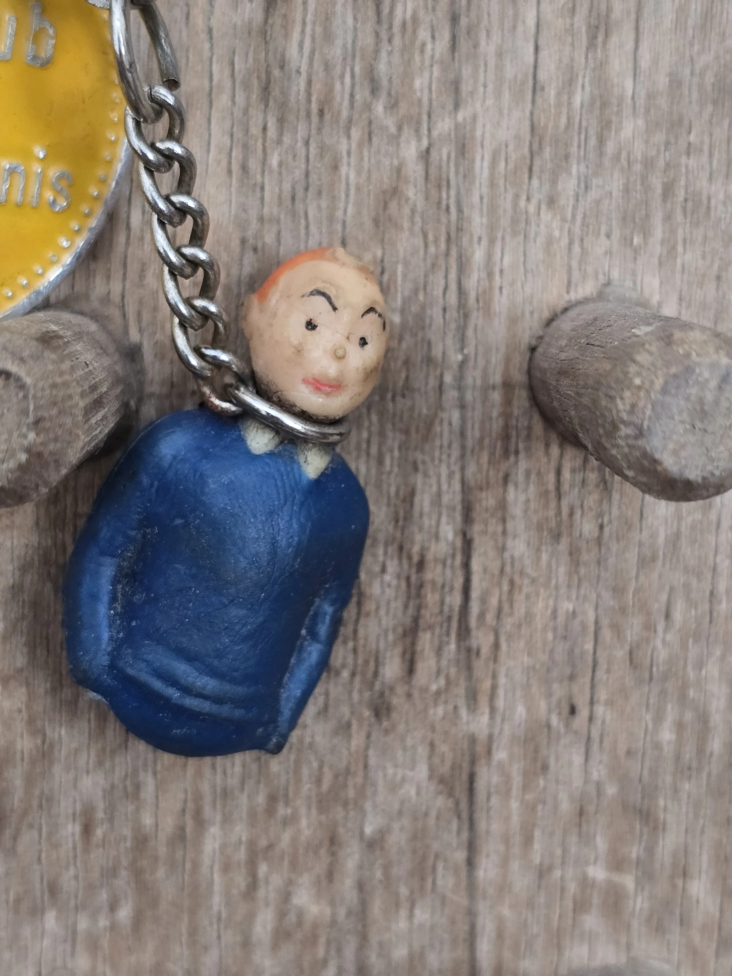 Front view of a vintage Tintin keyring with enamel tennis club disc.