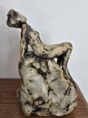 Reclining figure clay sculpture with coarse surface and hollow base