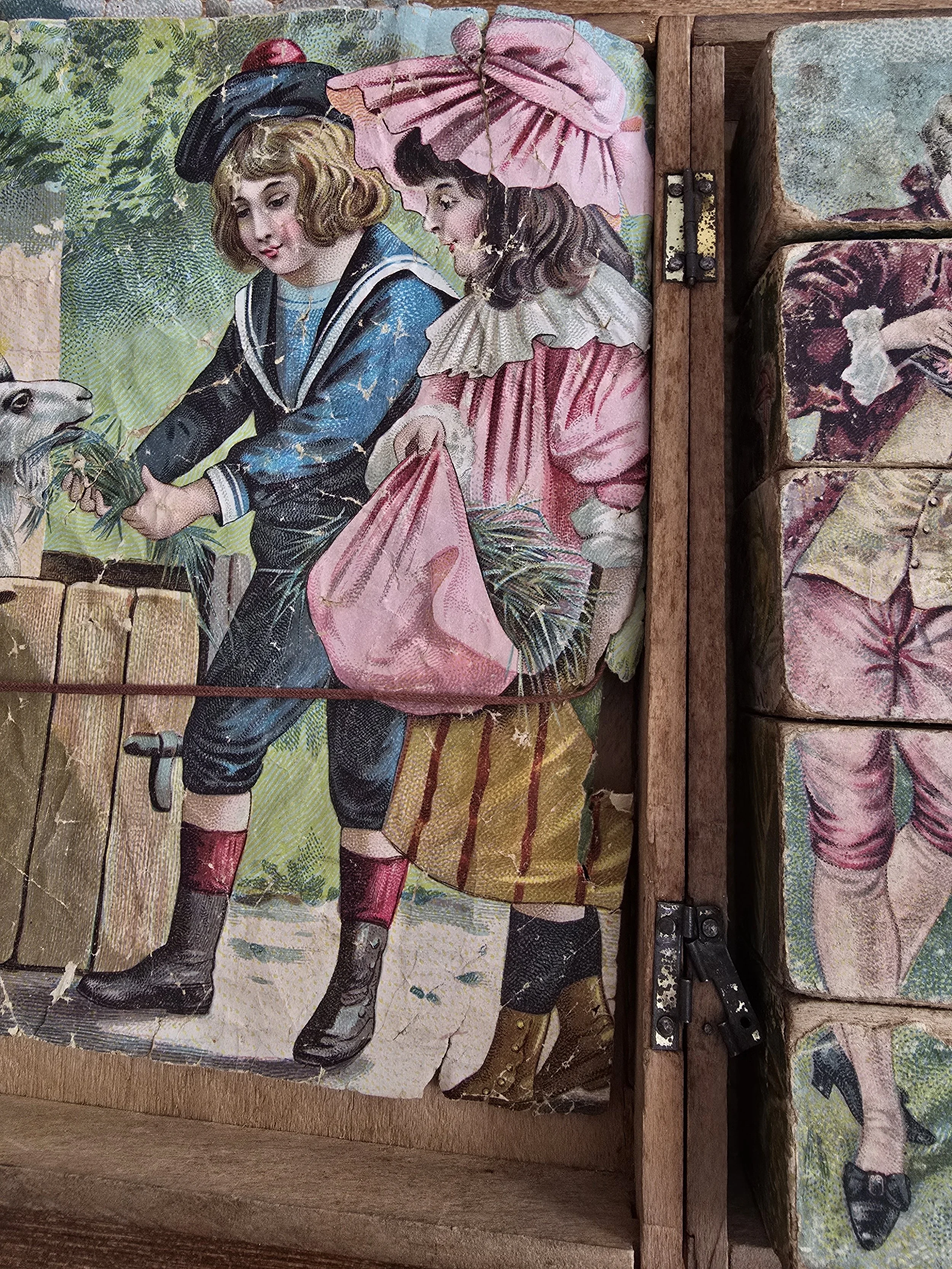 antique puzzle blocks showing fragmented pastel children scene