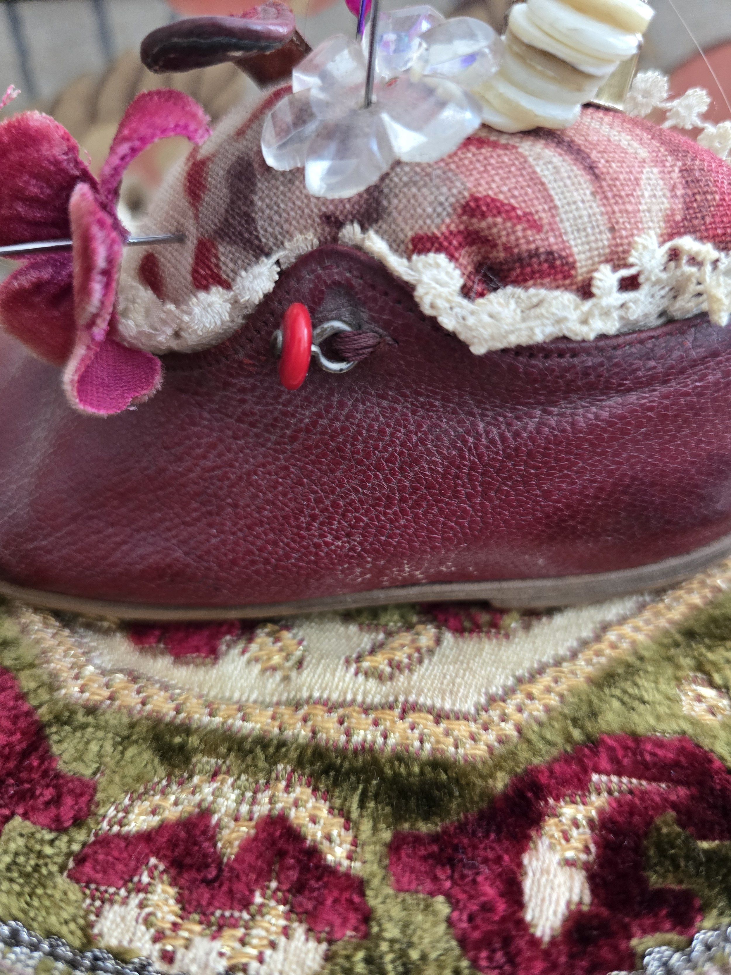 Close up of velvet flower and antique lace trim on the handmade pin cushion