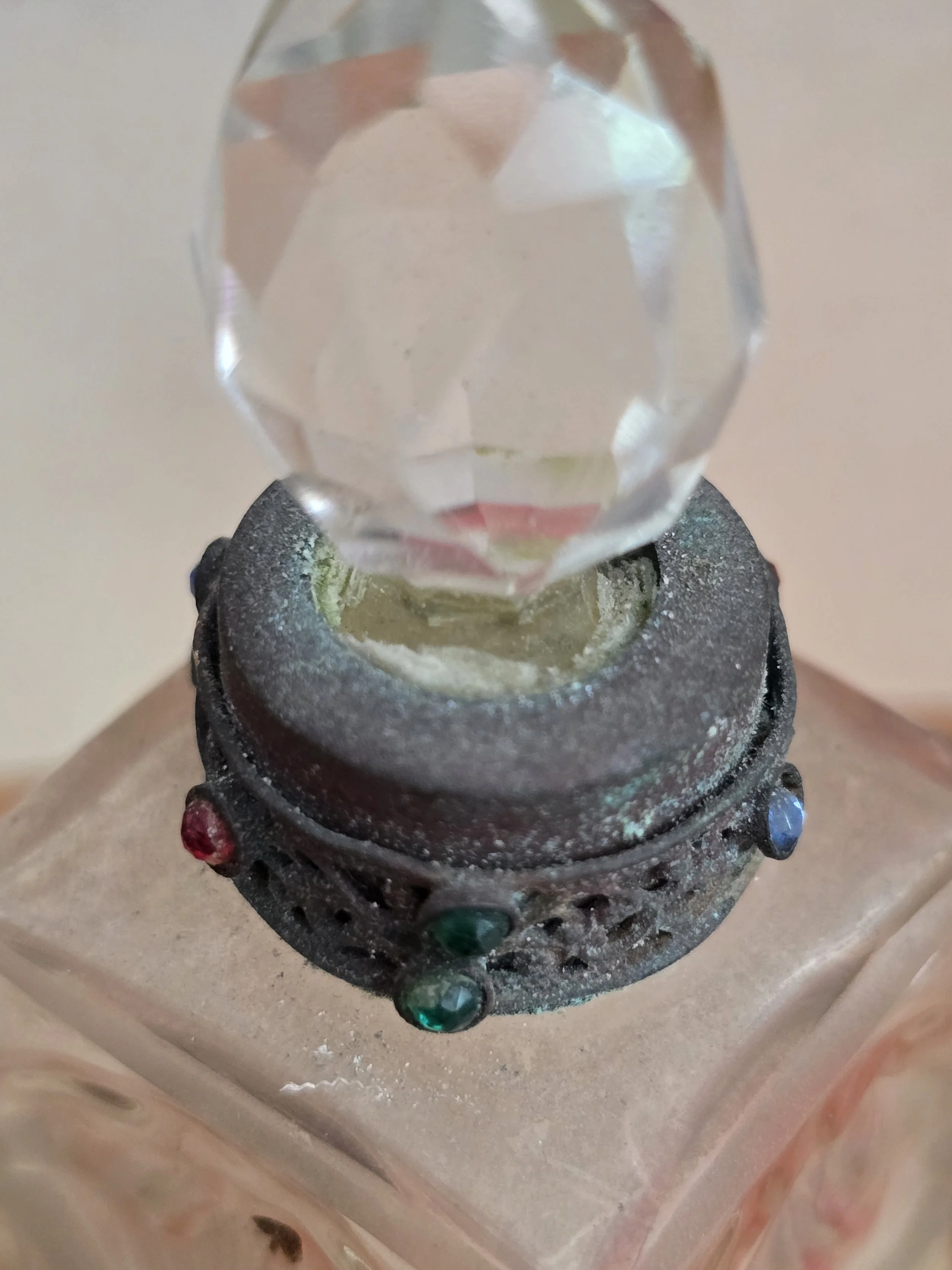 Detailed view of the decorative pierced metal collar with coloured paste stones and aged verdigris.