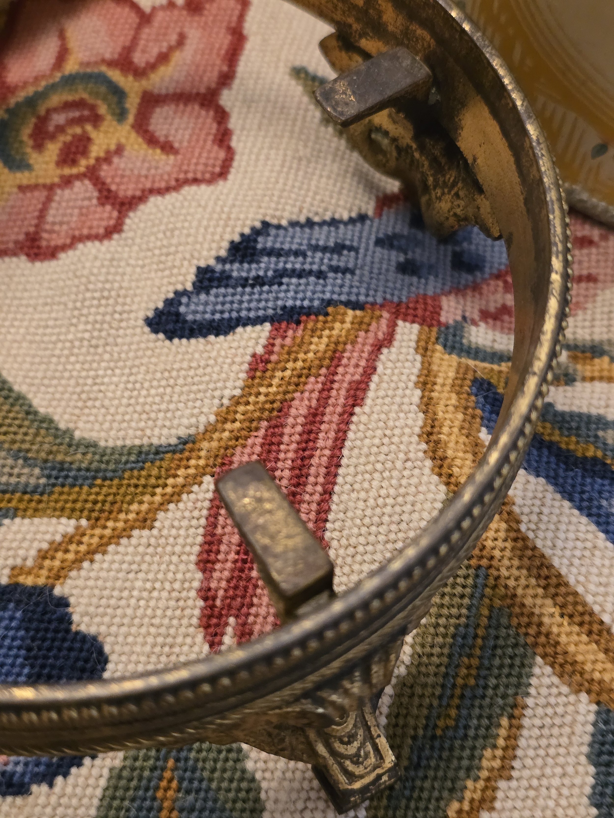 Interior view of vintage gilt metal stand showing the inward-facing supports for a bowl or pot.