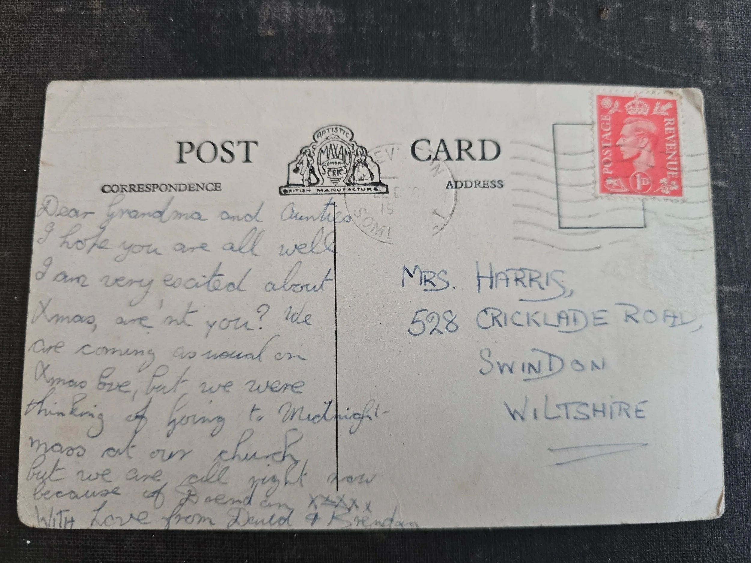 Reverse of posted vintage Christmas postcard with handwritten message, King George VI stamp and Swindon address.