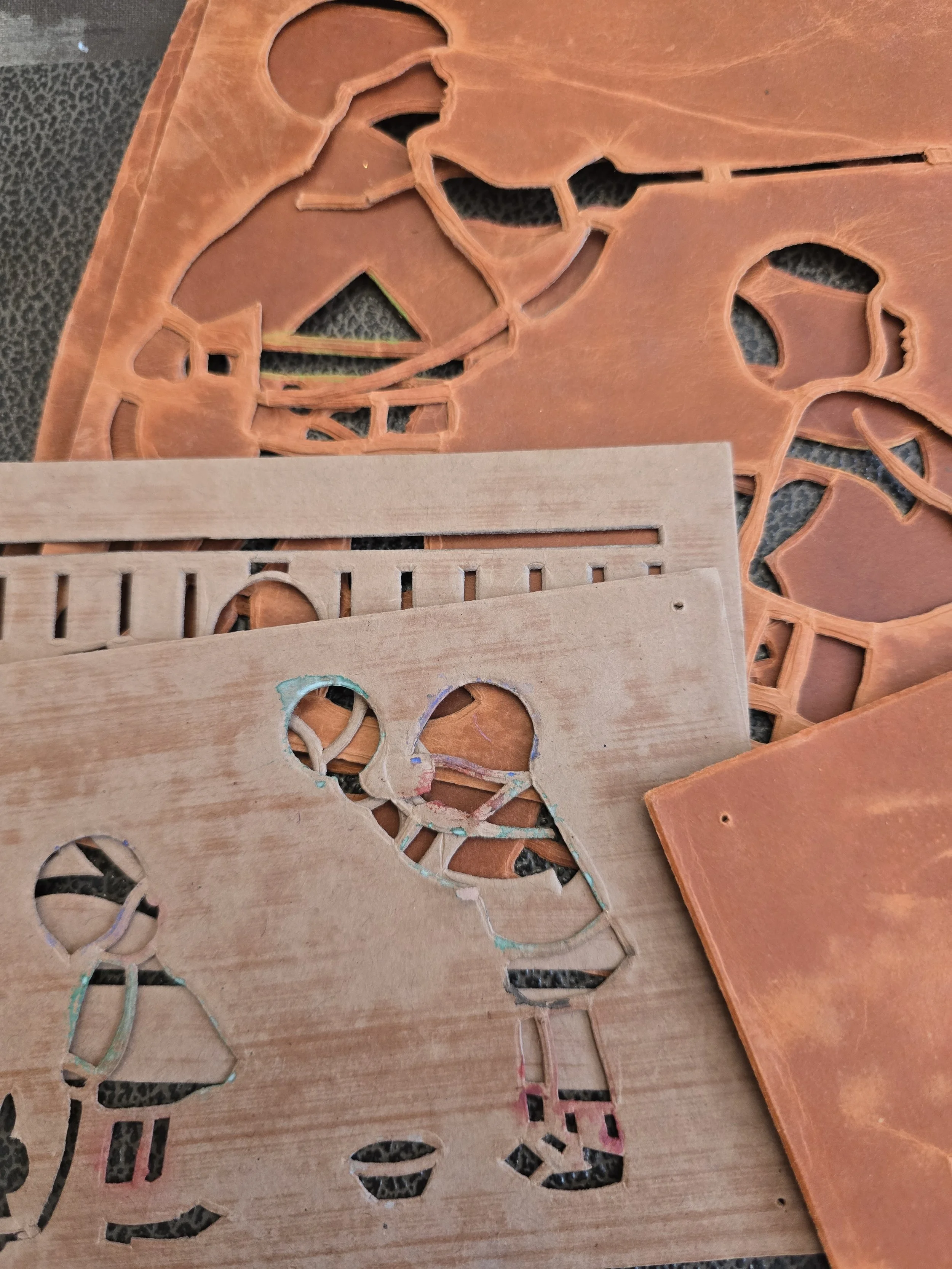 Eight vintage card stencils in faded terracotta and pale colours, including charming cut-out illustrations of children and decorative patterns.