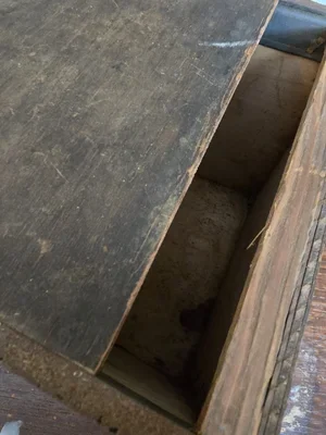 Sliding lid of antique wooden tea box with darkened patina
