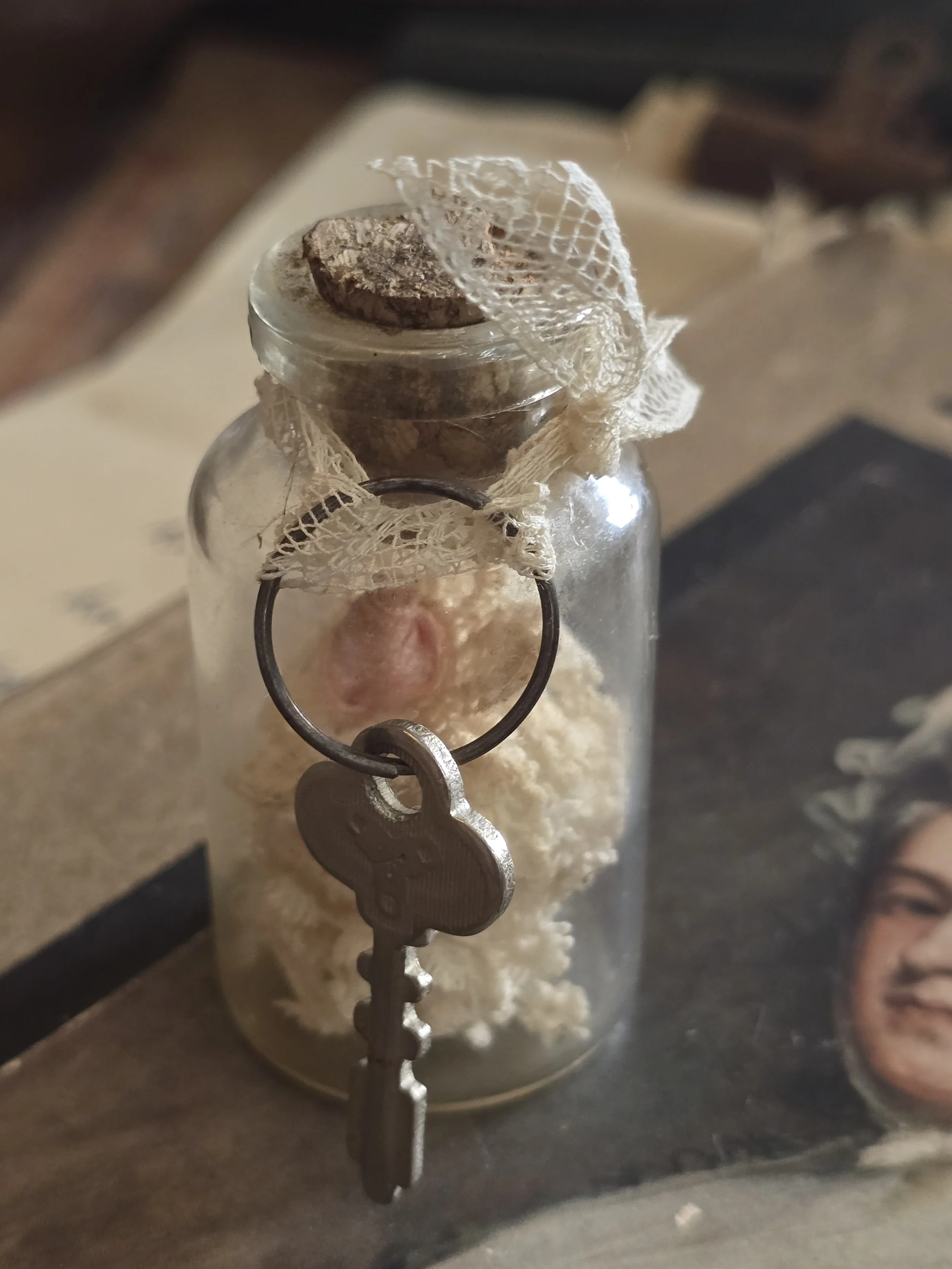 Antique found object composition in a glass bottle