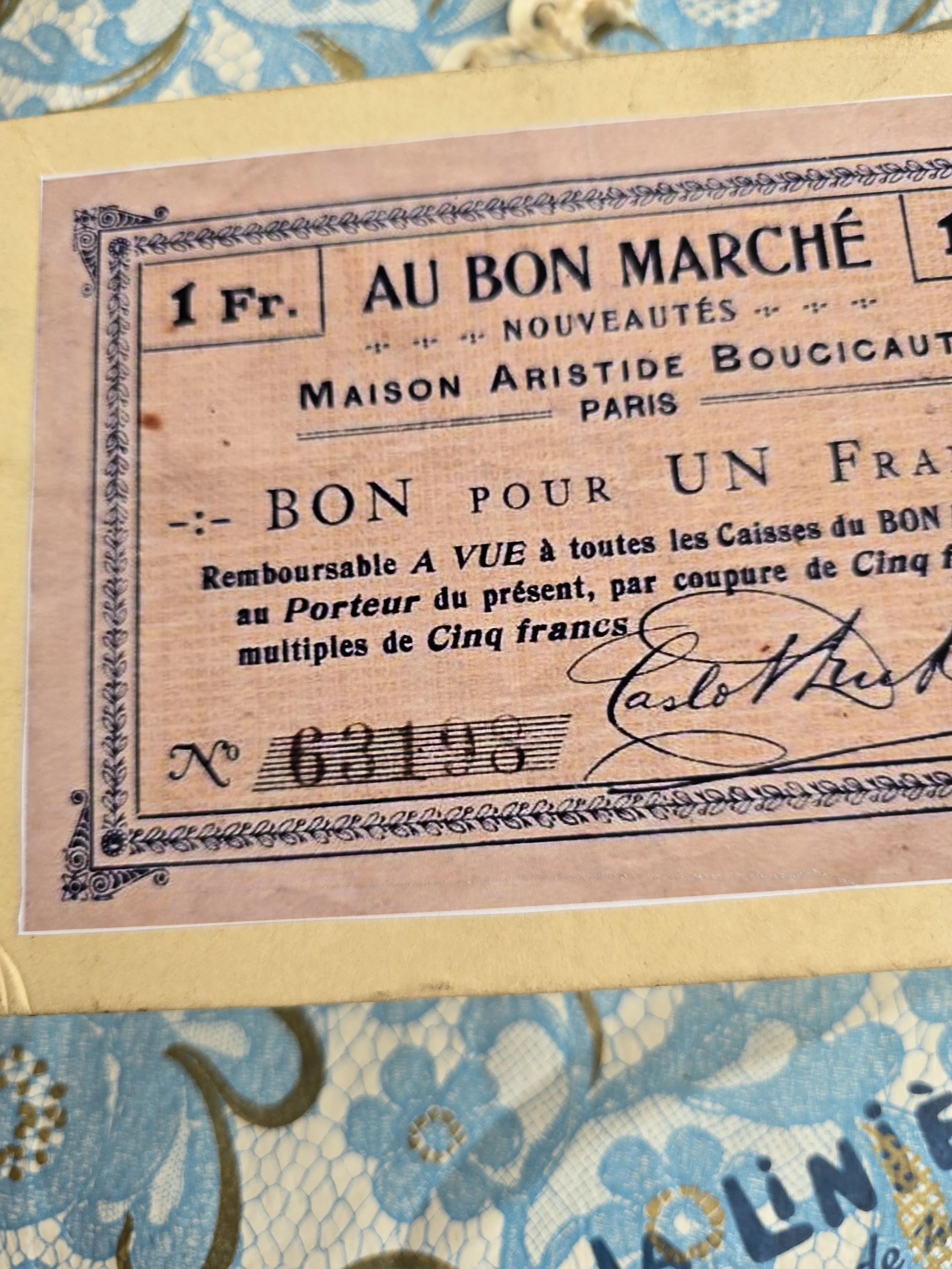 Studio made book box featuring a pink Au Bon Marché label and aged book cover.