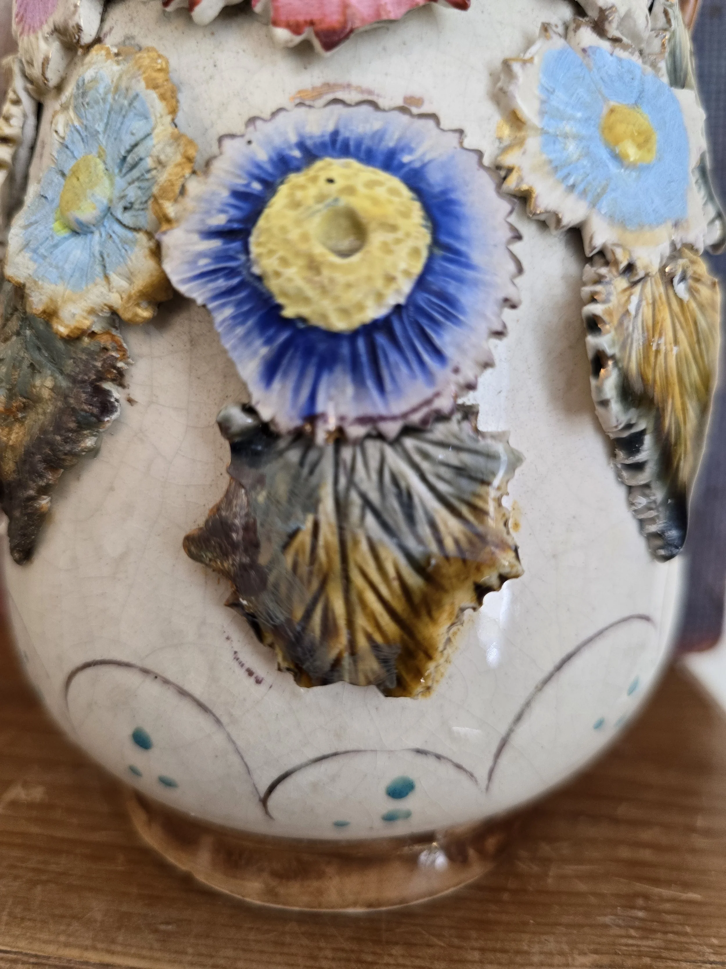 close-up of applied floral decoration with gilded highlights