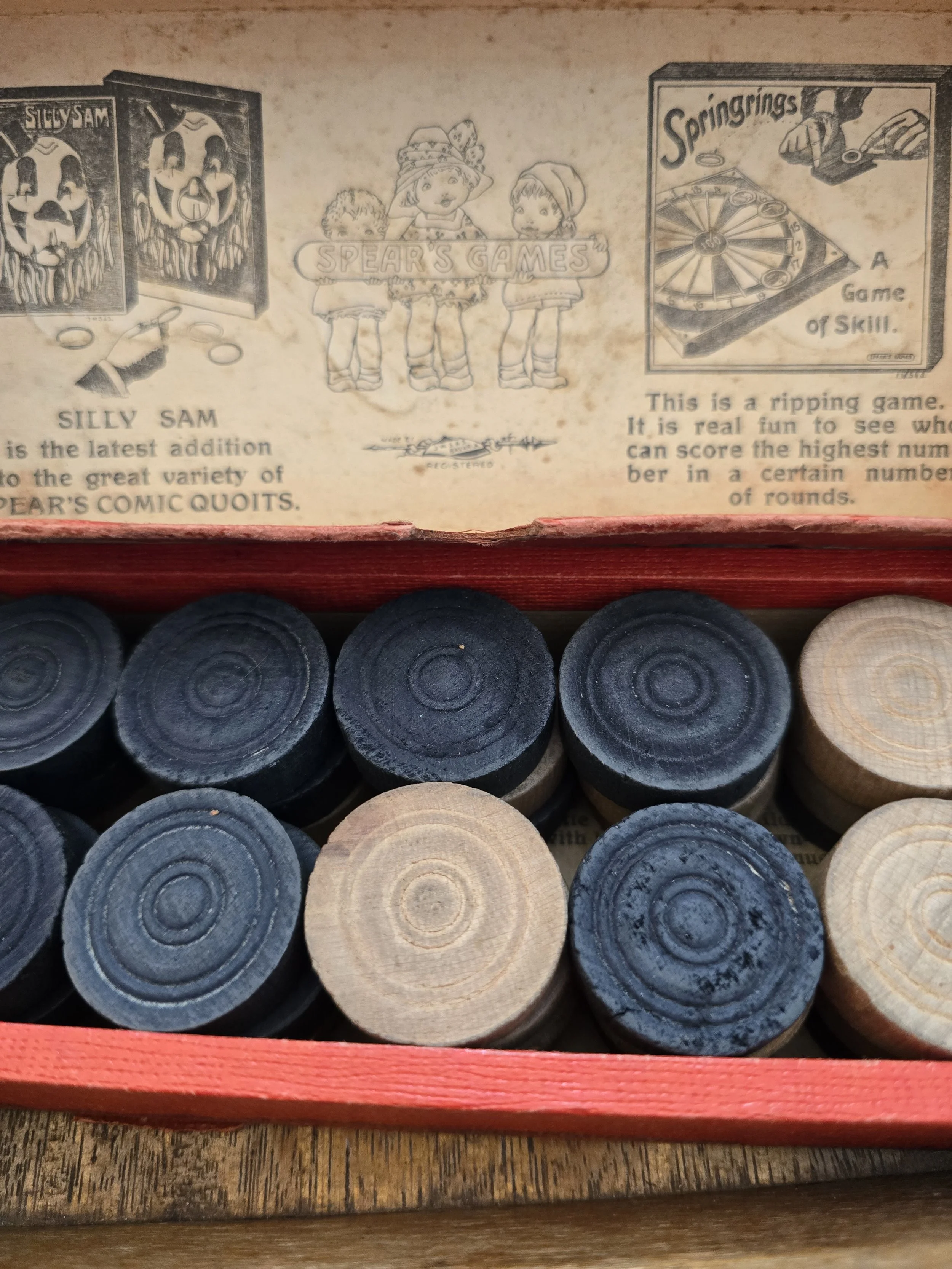 Wooden draughts counters inside original game box