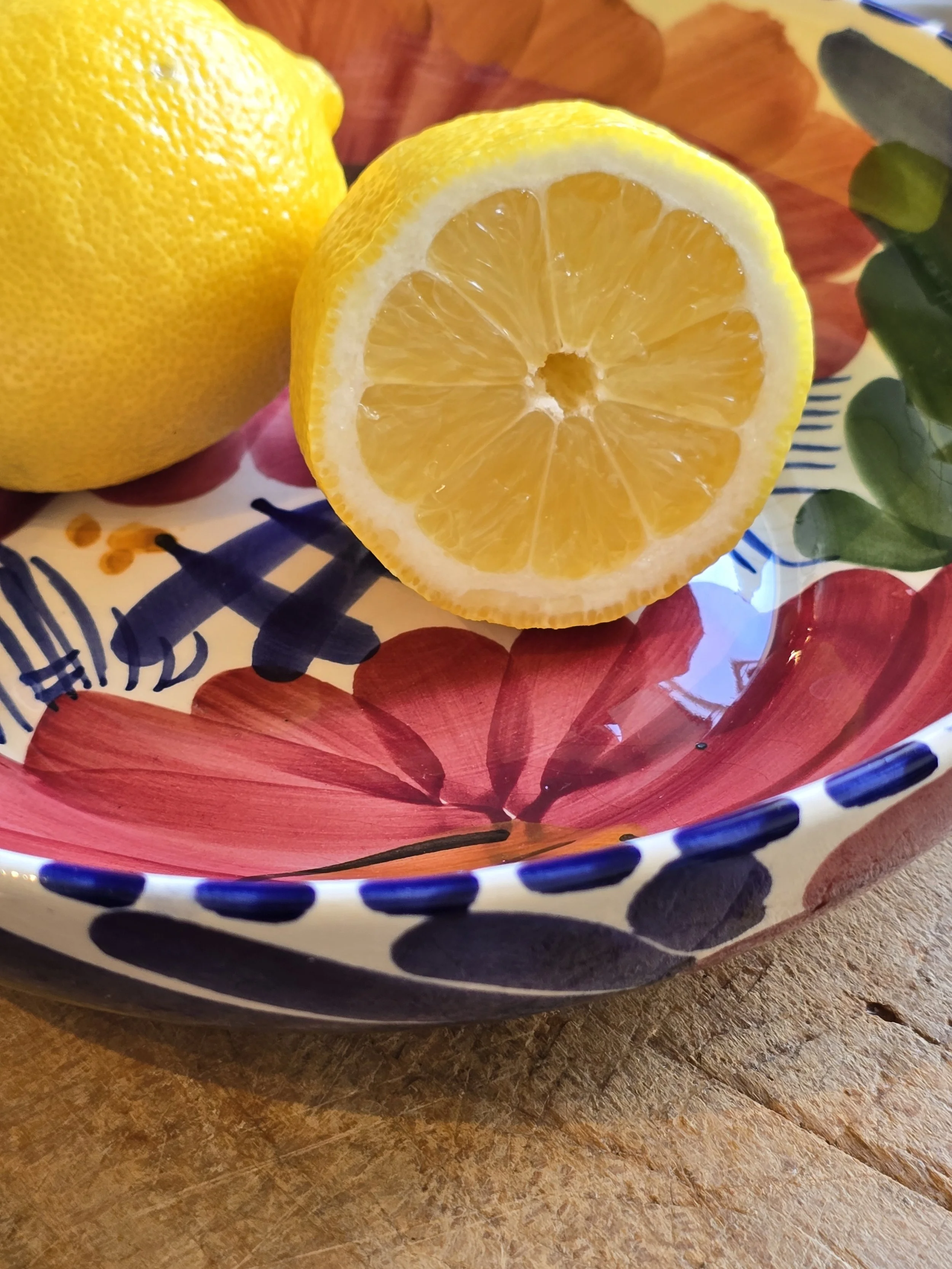 Italian-style floral ceramic bowl with lemons, rustic table setting
