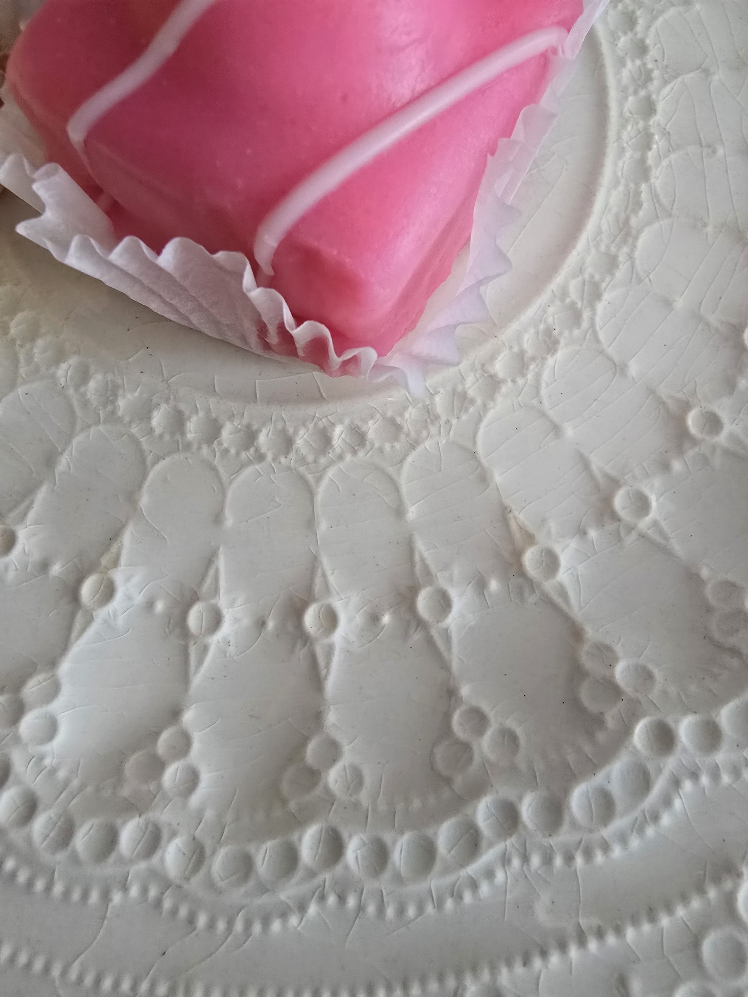 close up of victorian style plate showing fine craquelure glaze and raised decoration