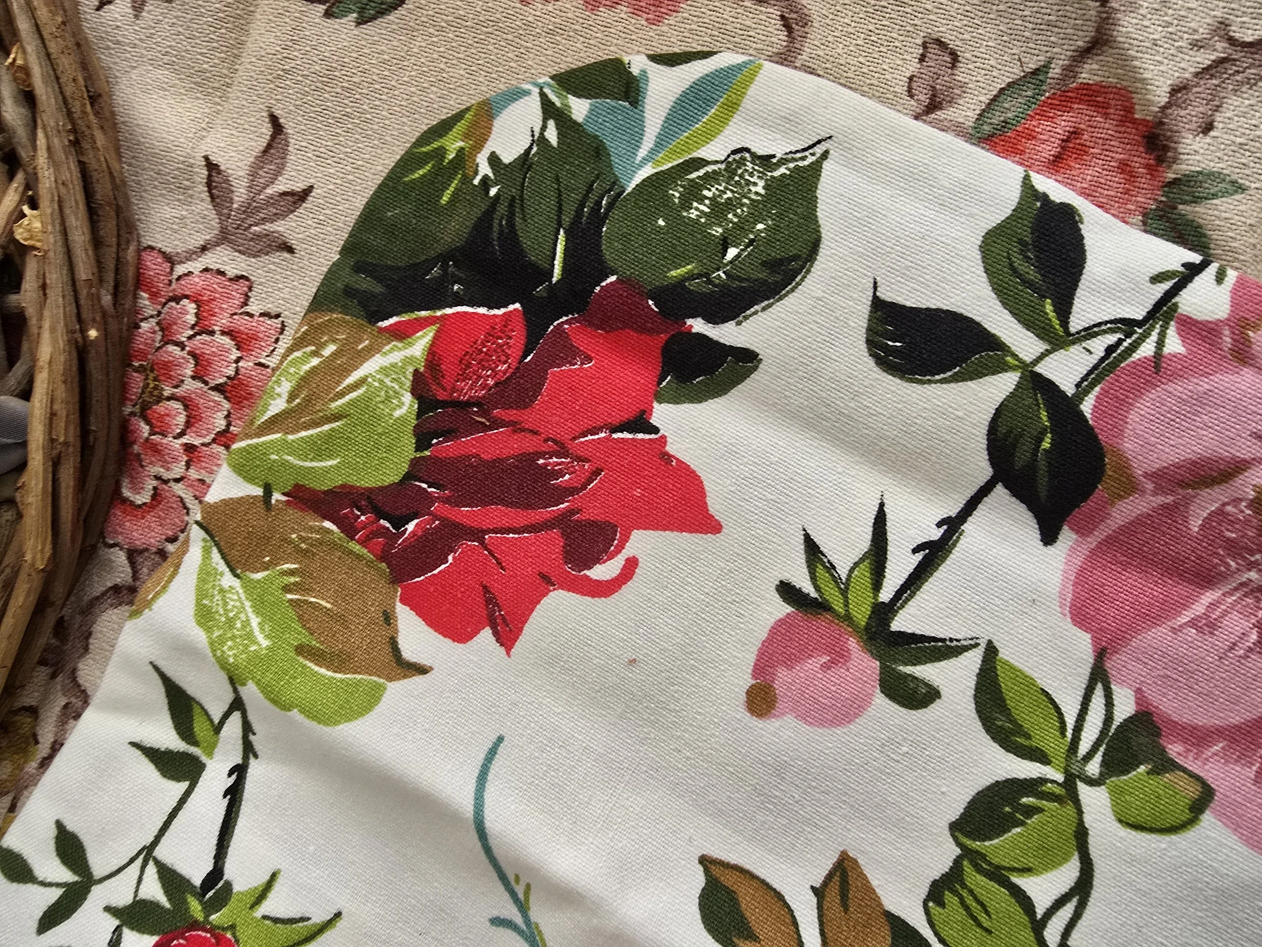 Retro-style floral hot water bottle cover in red, pink, and green botanical print on white cotton.