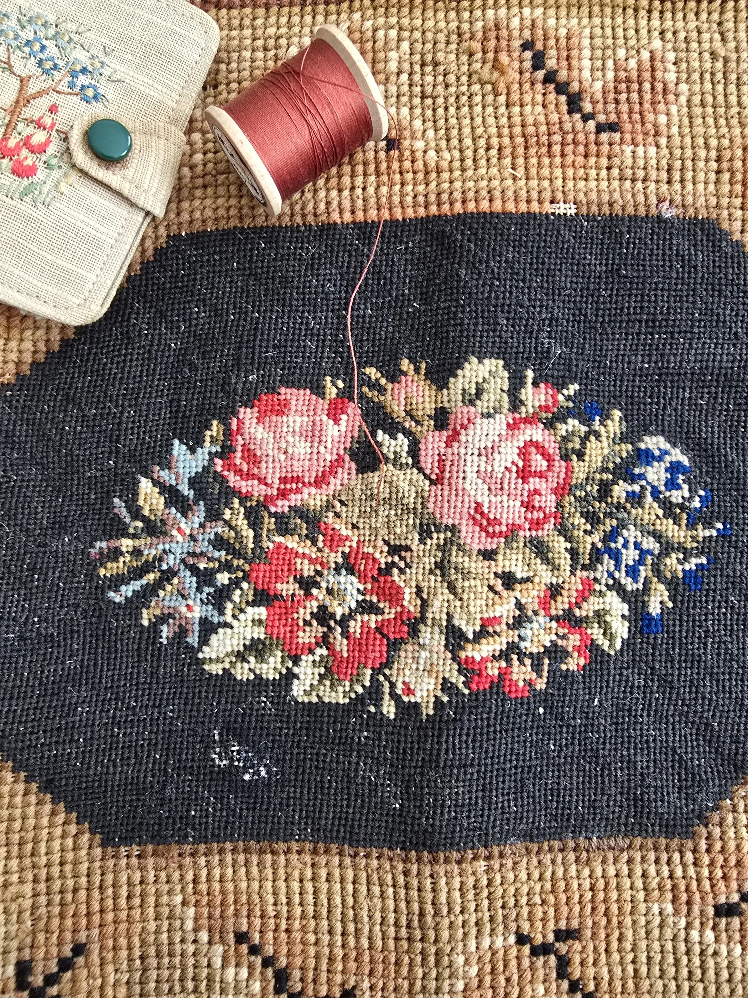 Antique 1890s floral needlepoint panel with roses and red flowers on black ground
