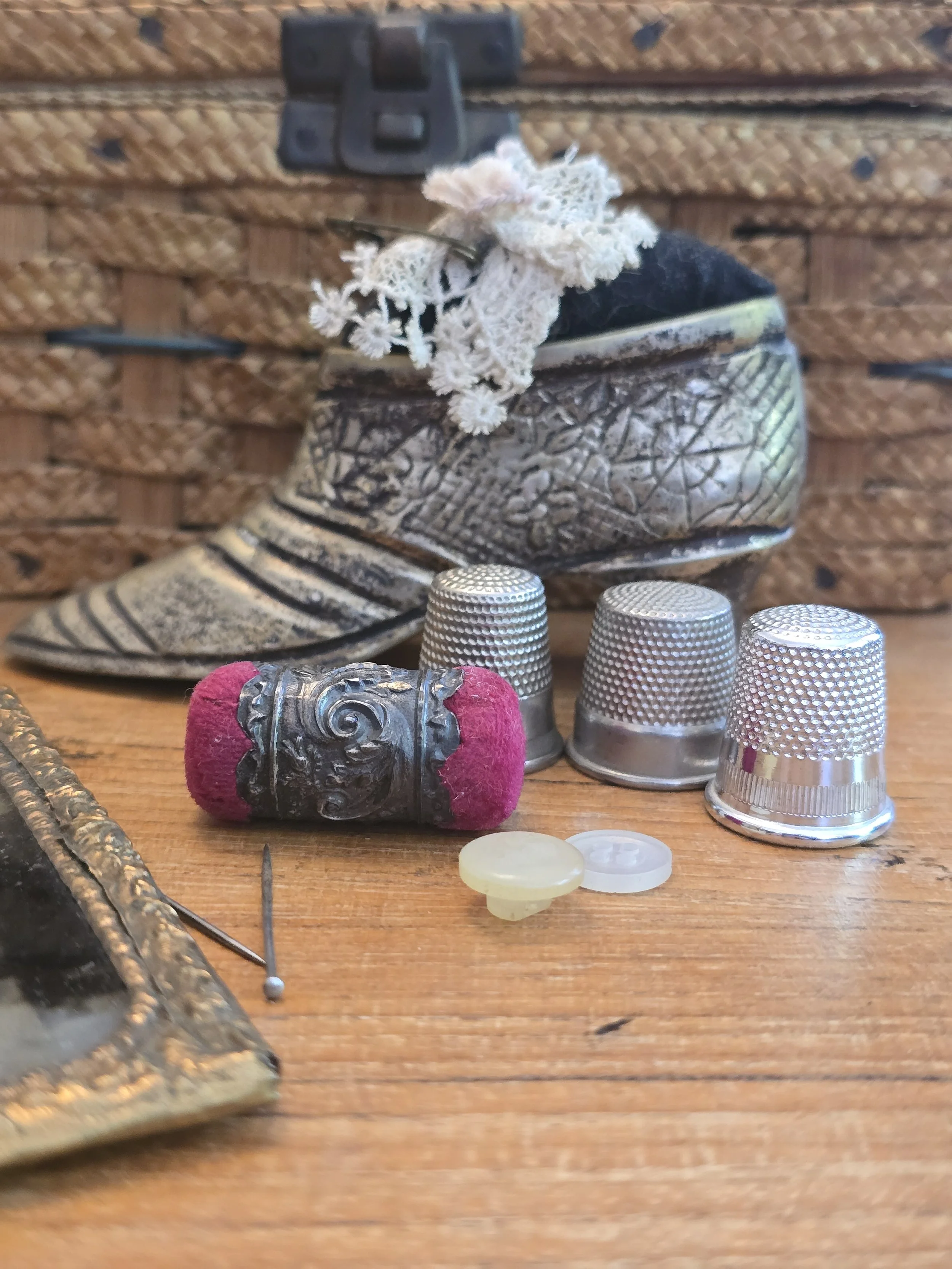 Antique Victorian emery needle sharpener with ornate metal mount and original wool cushions.