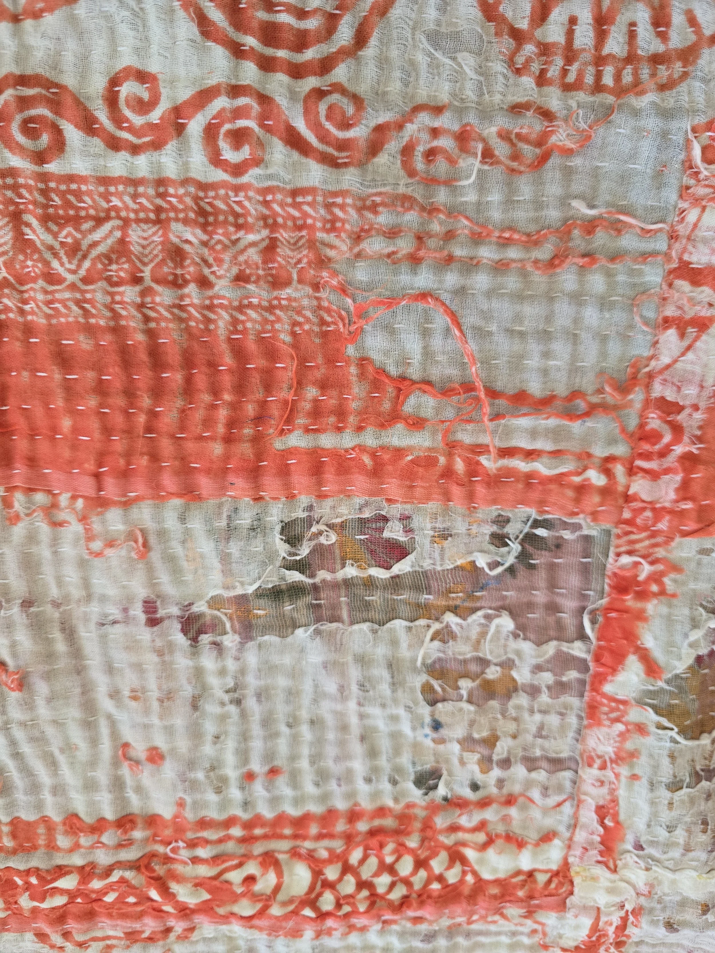Worn cotton kantha textile with beautiful texture, fraying edges and layered patchwork construction.