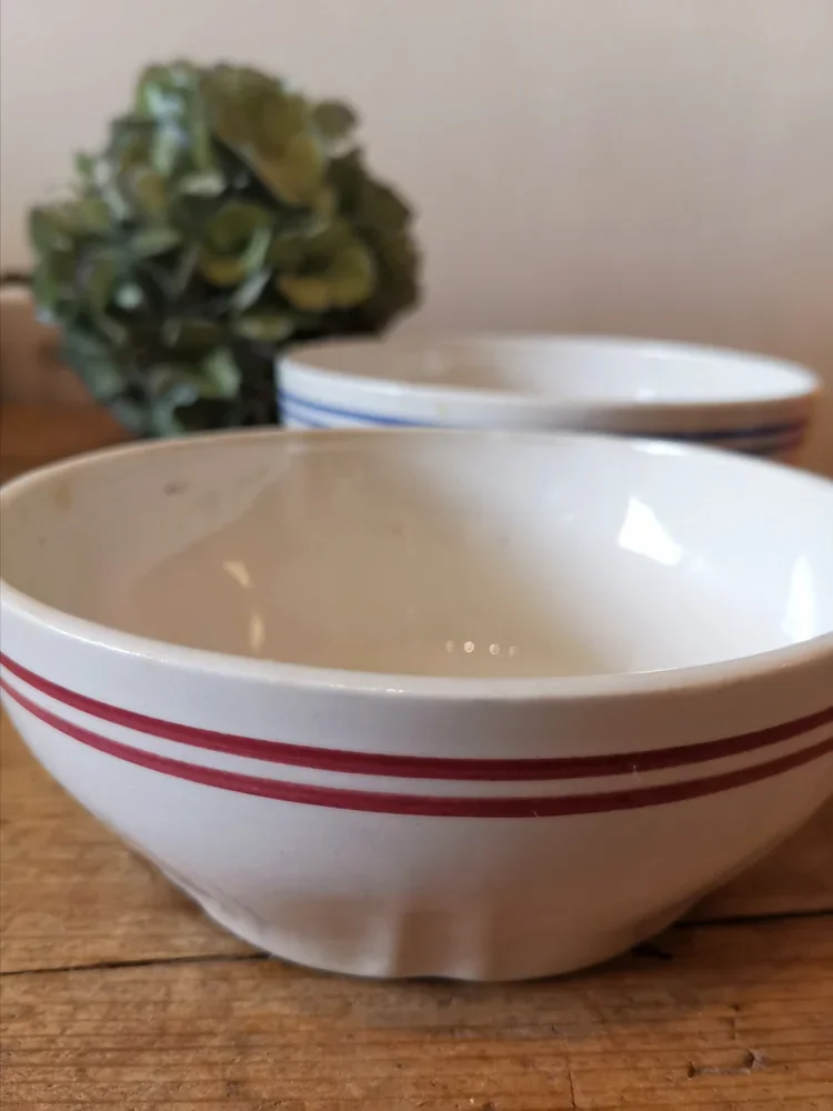Close-up of rare Moulin de Loups striped faience bowls in classic French café style.