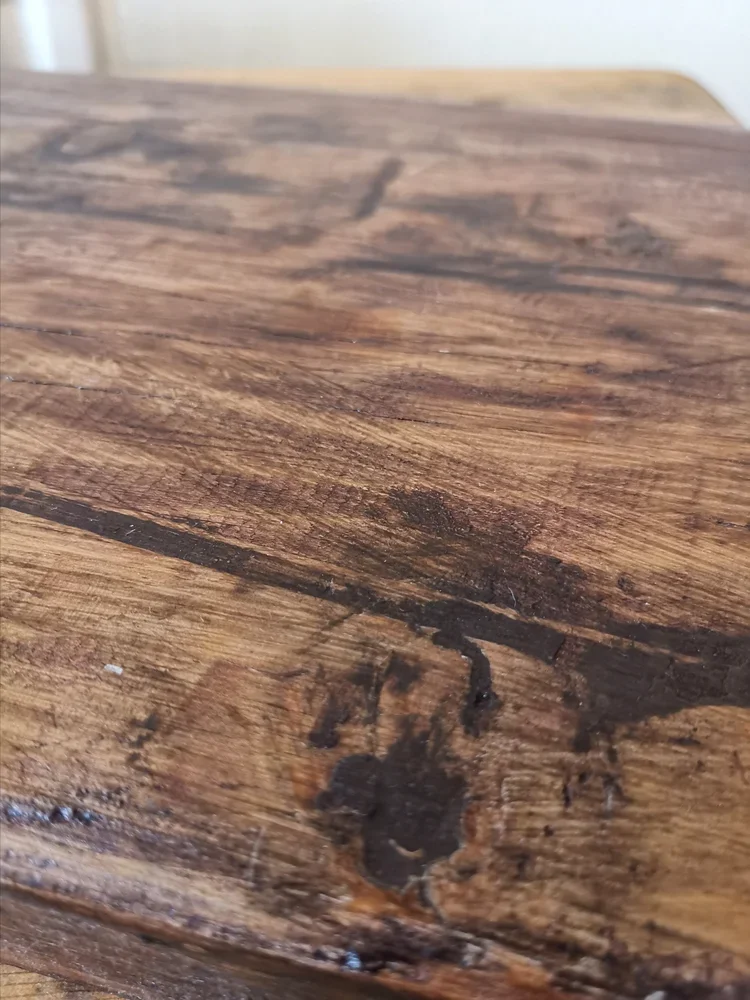 Close-up of French vintage oak cutting board handle showing thick rustic wood grain
