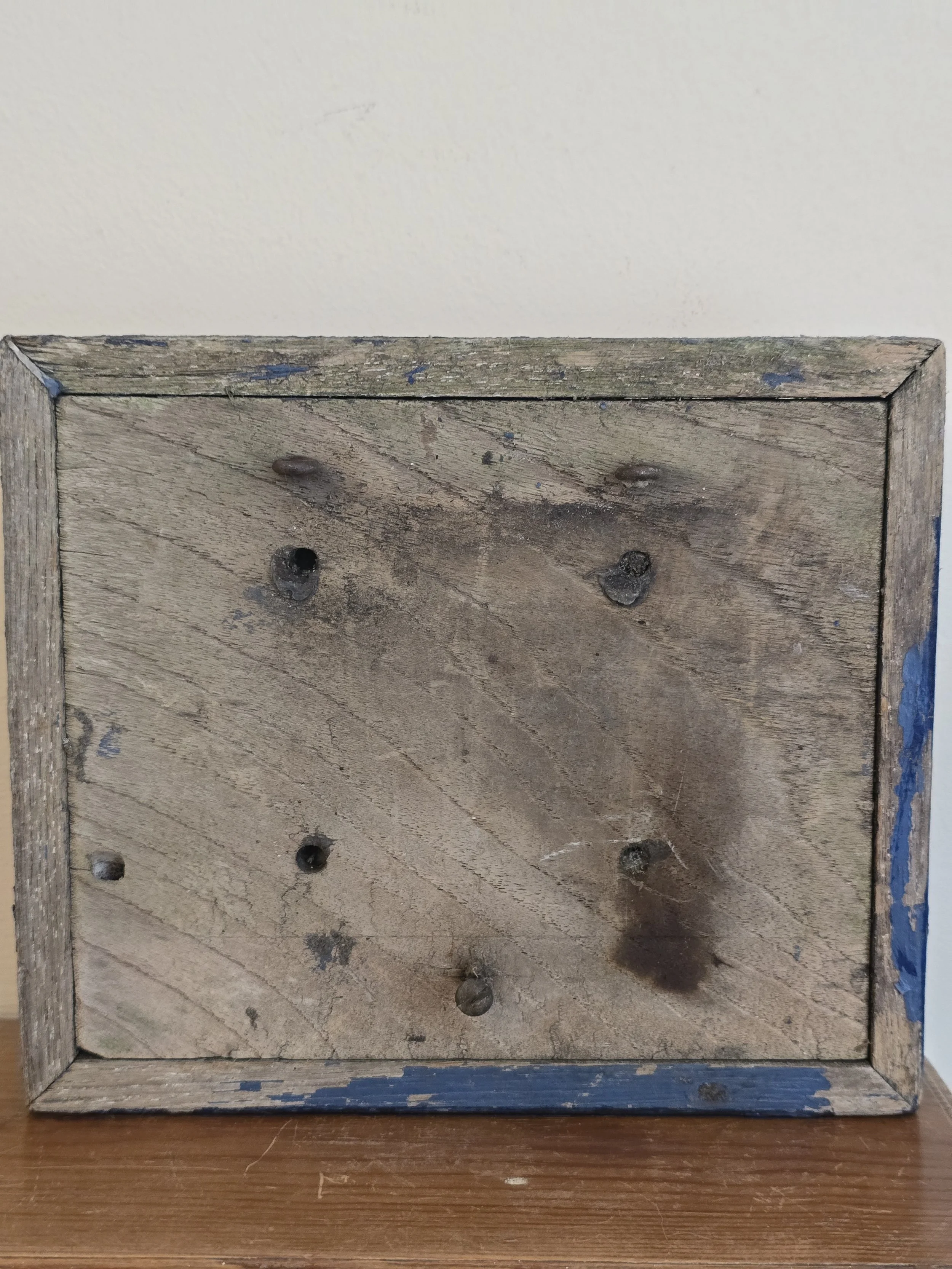 Reverse of vintage wooden number sign showing original construction and aged timber.