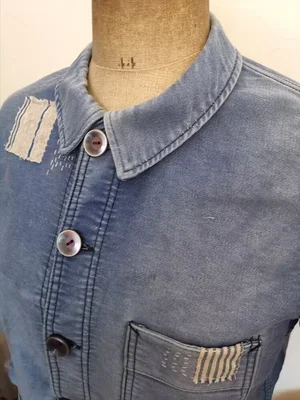 Close-up of pocket with striped antique ticking patch and sashiko stitching.