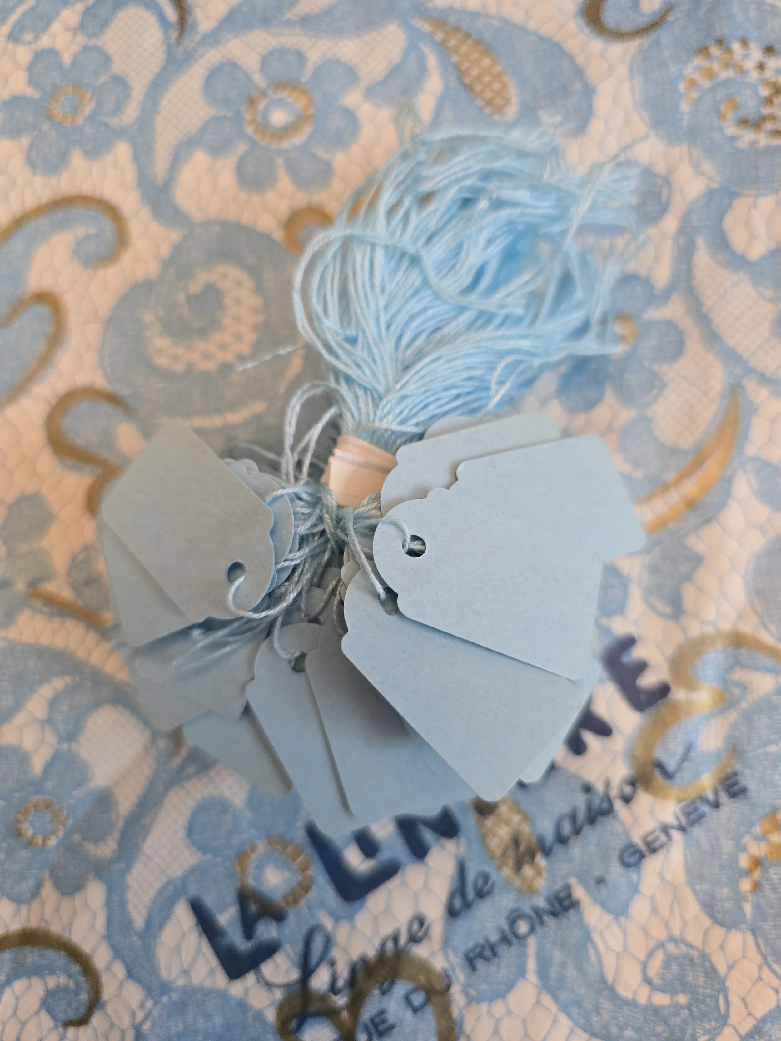 Vintage French blue price tags gathered on their original pale blue cotton threads, approximately 100 tags in the bundle.