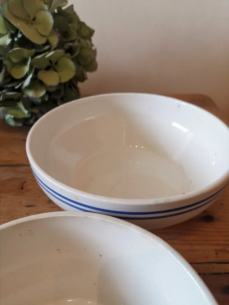 Side view of 1940s Moulin de Loups shallow bowls with striped decoration, French country kitchenware.